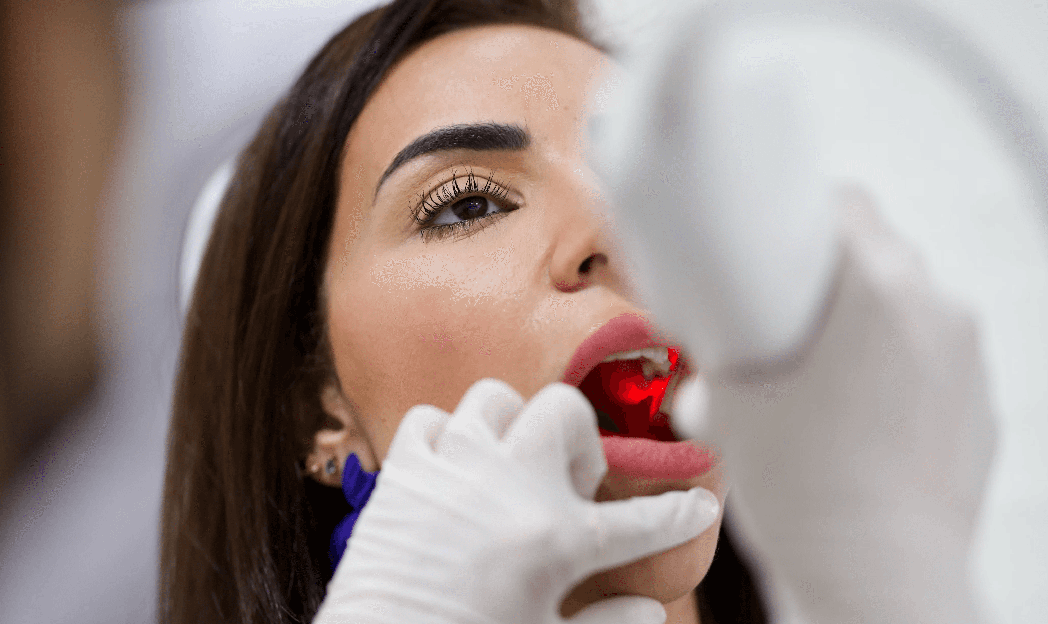 Woman having a dental checkup while wearing teeth retainers