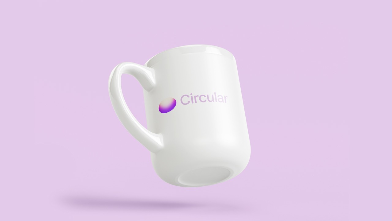 White ceramic mug floating against a lilac background, printed with a small purple-pink gradient pill logo and the word “Circular” in matching lilac type.