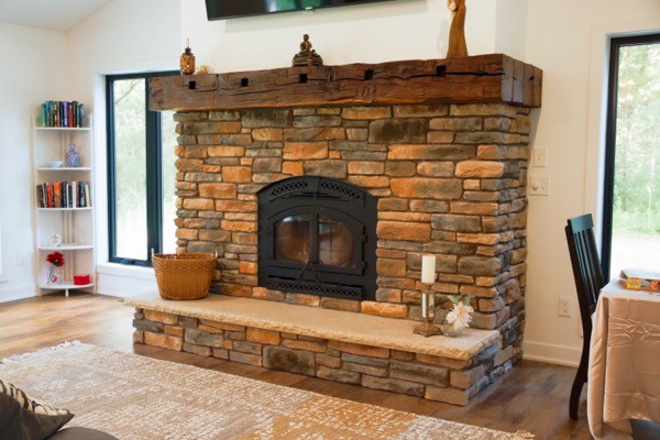 Stone fireplace with wood floor dark wood mantle