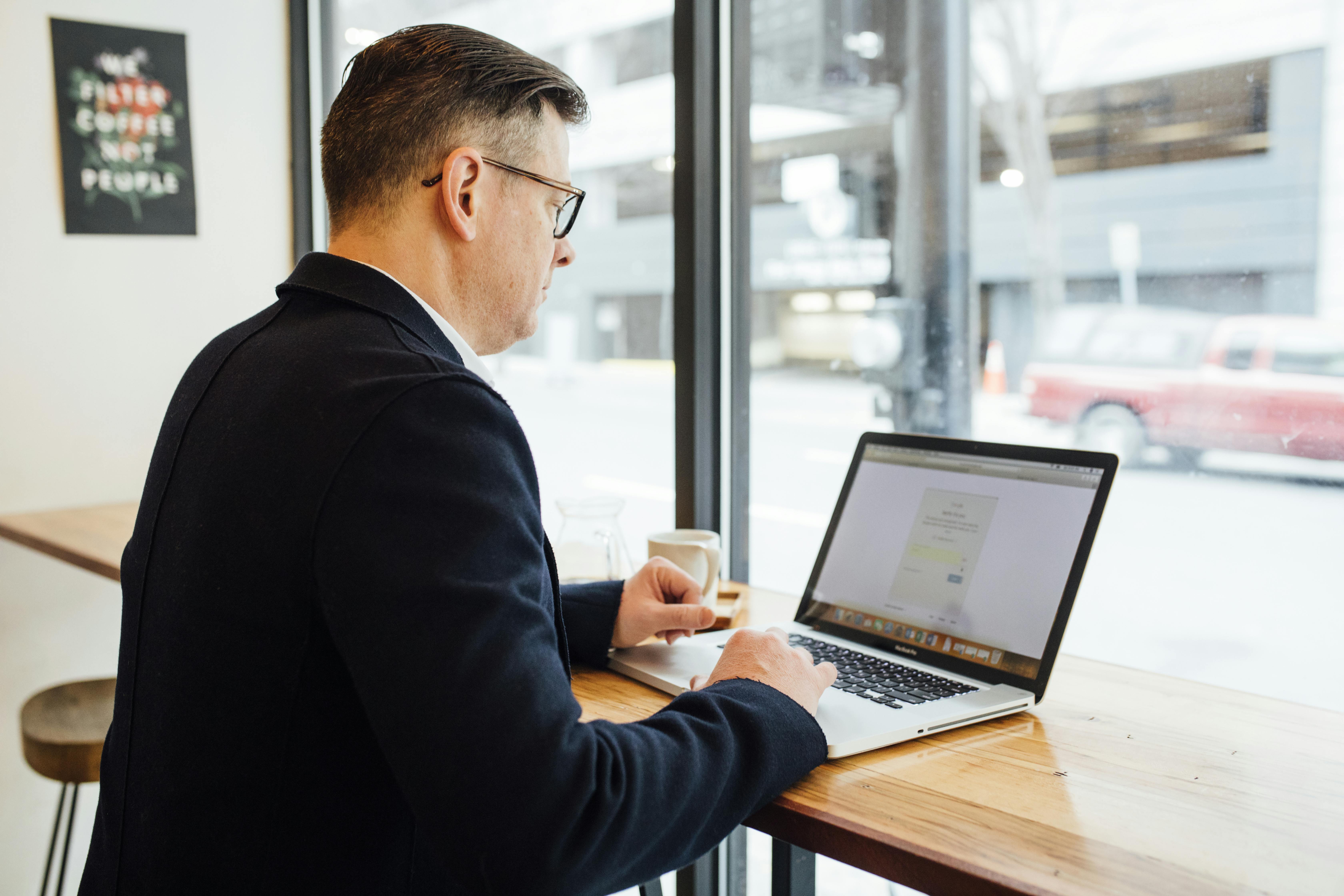 Man using macbook with optimal length for cold DMs and mastering the art of engagement