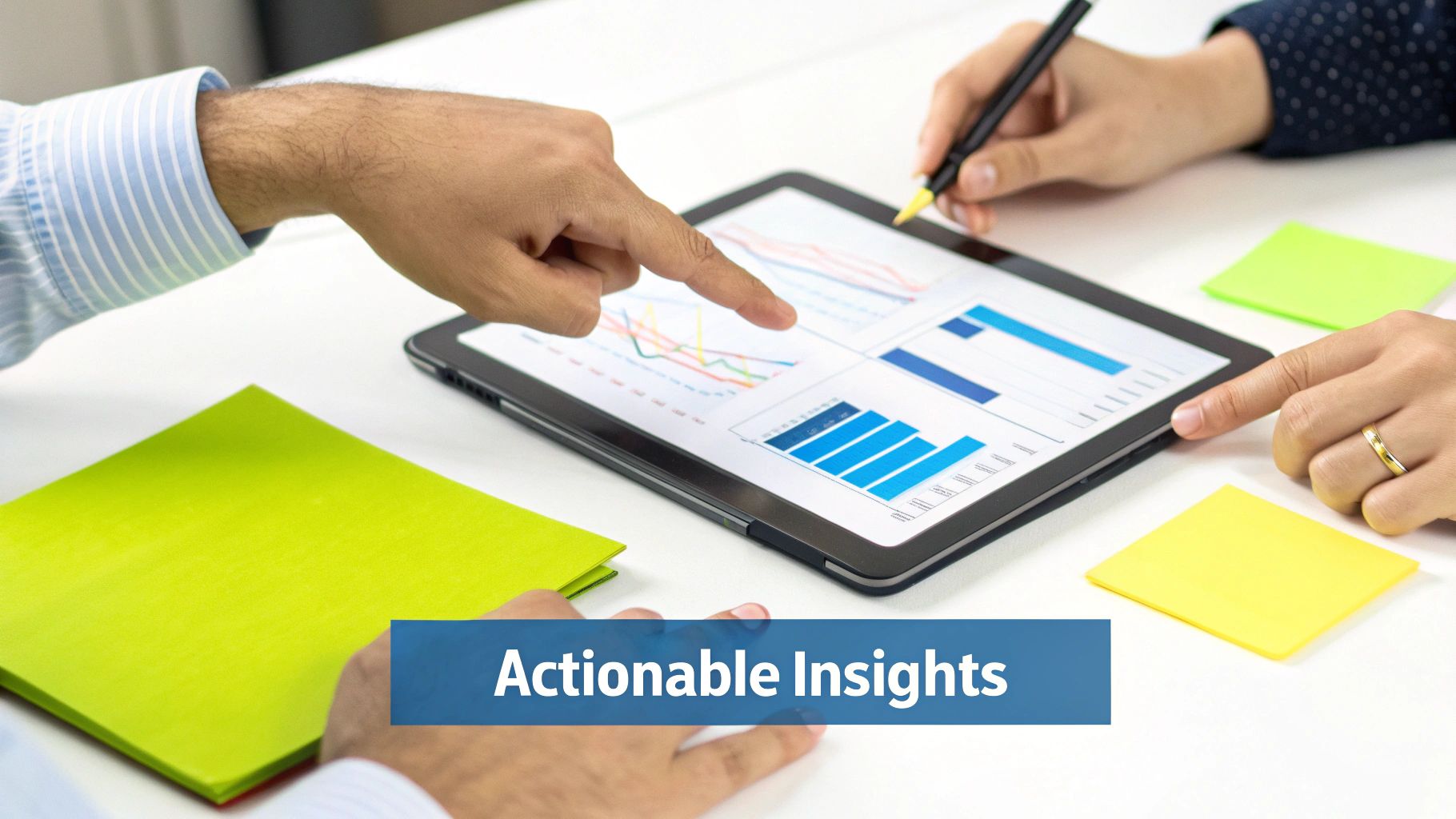 Hands pointing at a tablet displaying business charts, representing data analysis and actionable insights.