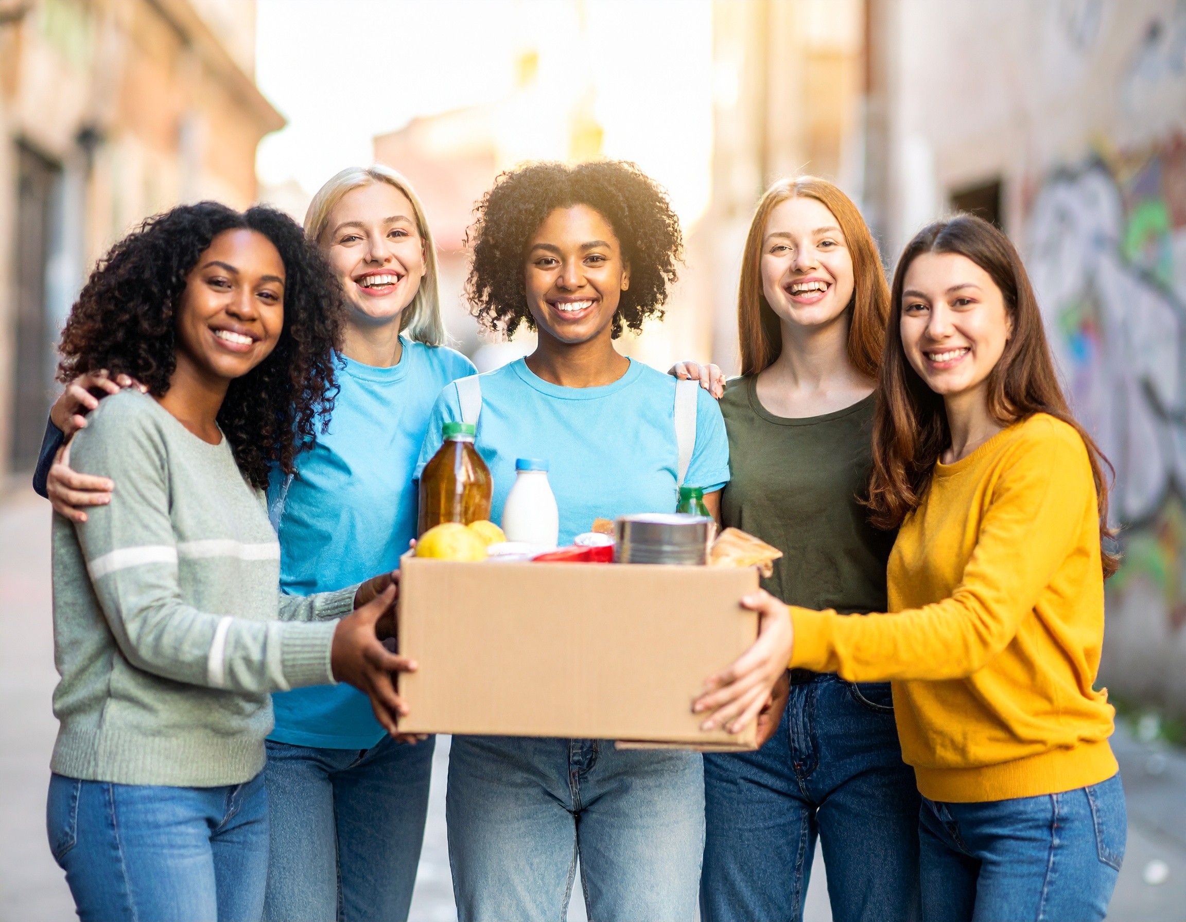 A rustic table set with various traditional pastries and a small bottle, surrounded by green foliage.