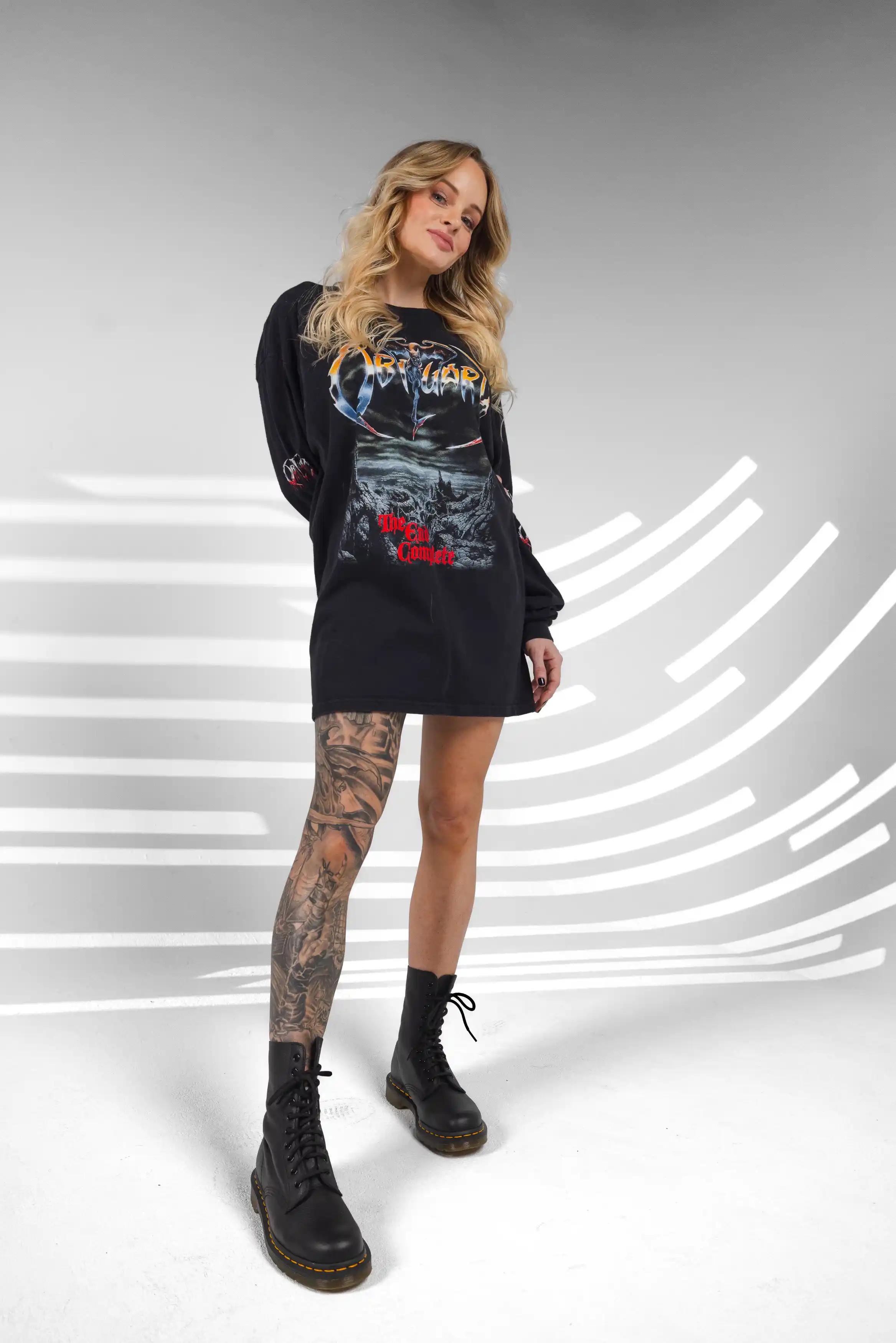 Entrepreneur showing off her tattoos in a bold, editorial studio pose, captured during a Tampa personal branding photoshoot