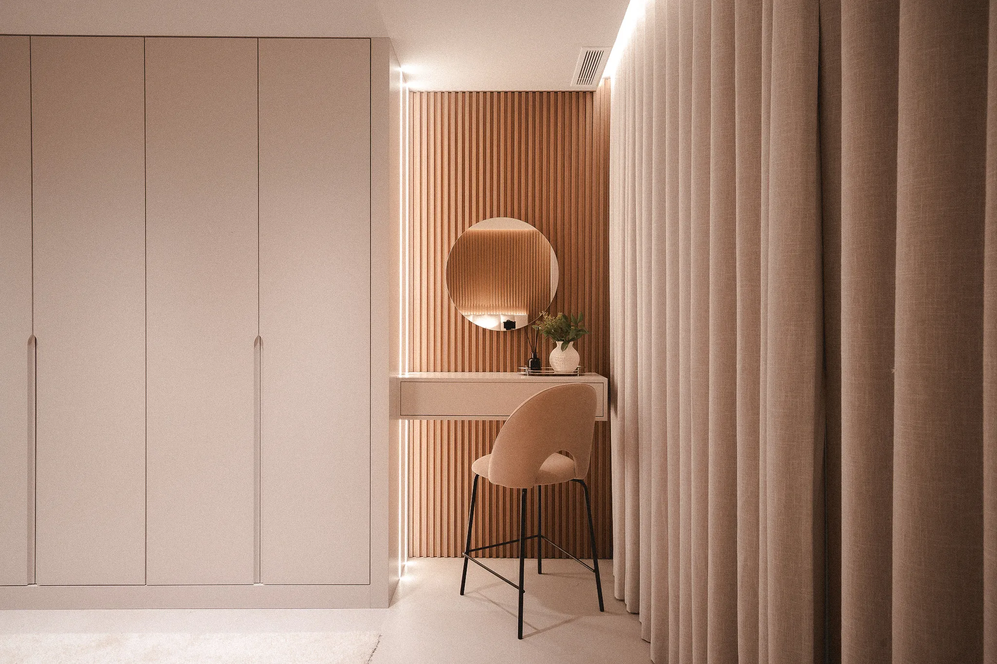 Custom-built workspace with integrated shelving, warm wood detailing and concealed lighting.