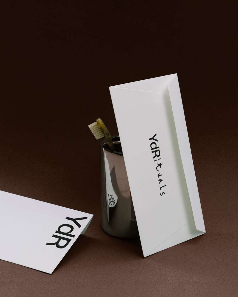 A photo of some printed media with the logo of Ydrituals against a brown background.