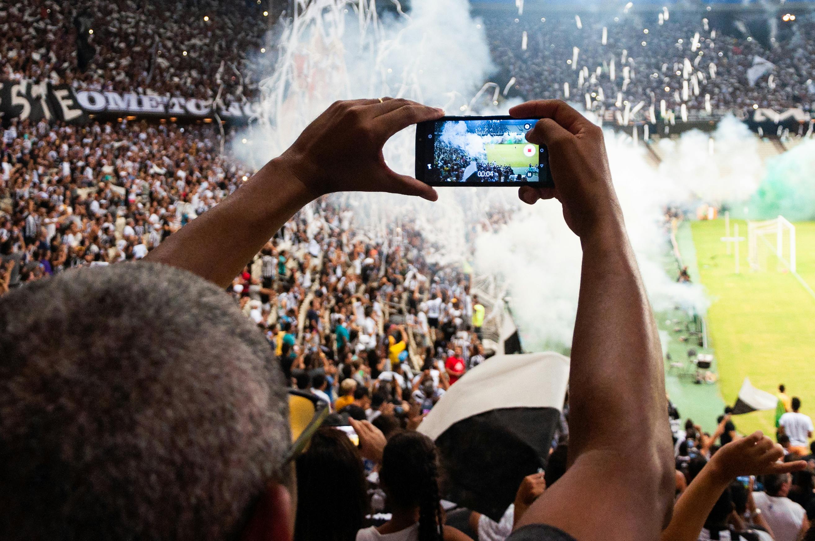 Excited fans cheering at a sports game, celebrating a big moment—just like we’re gearing up to celebrate big improvements to ROGER’s signer flow!