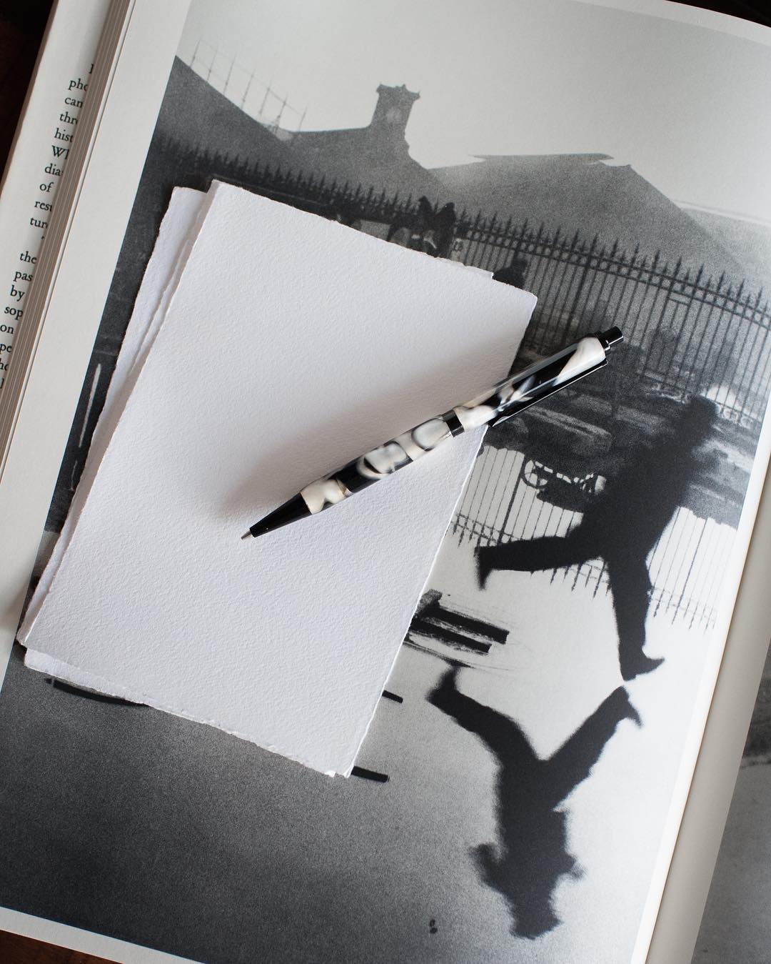 Full moon rising over a dark, silhouetted mountain ridge.