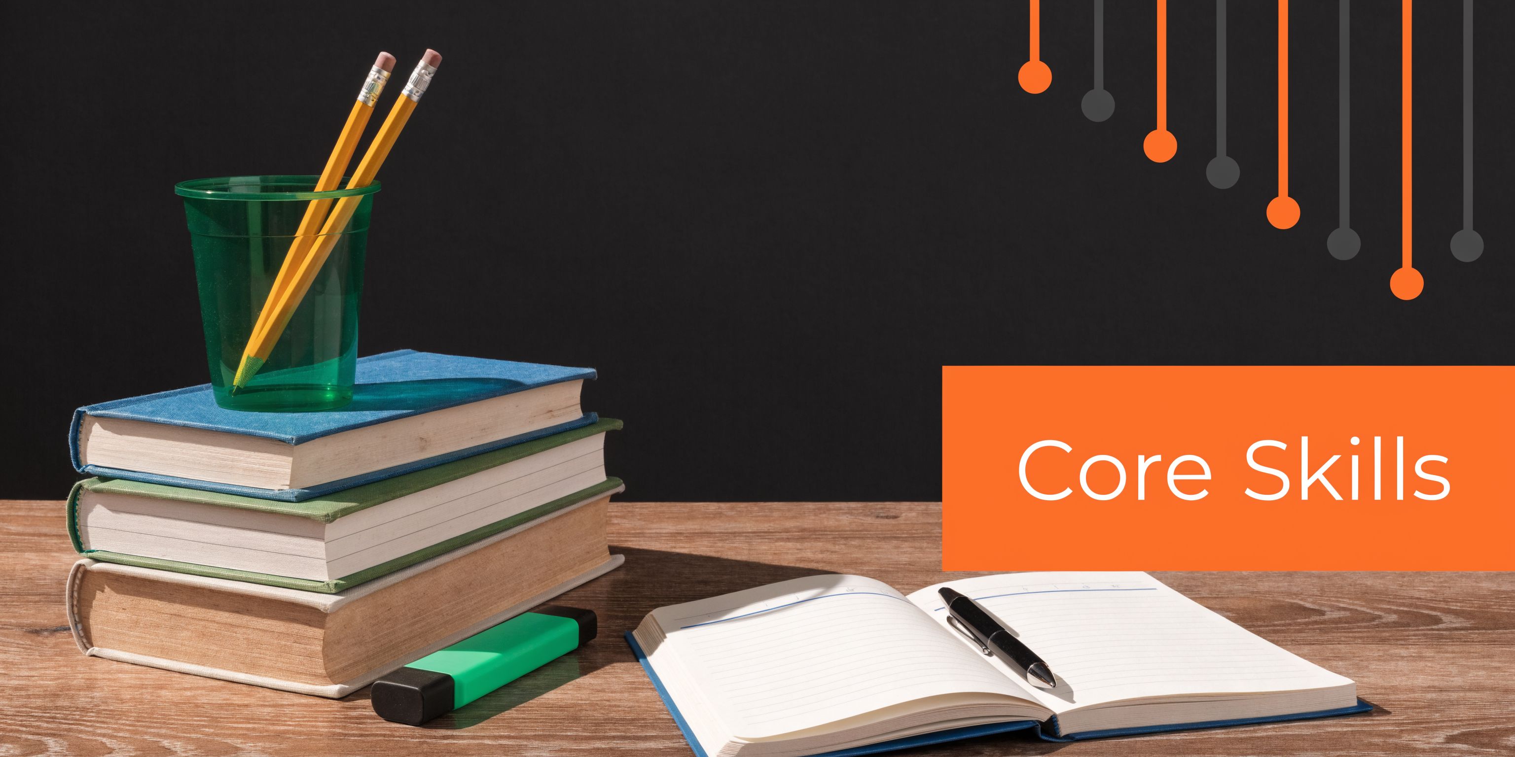 A stack of books with pencils in a cup, a green highlighter, and an open notebook on a desk.
