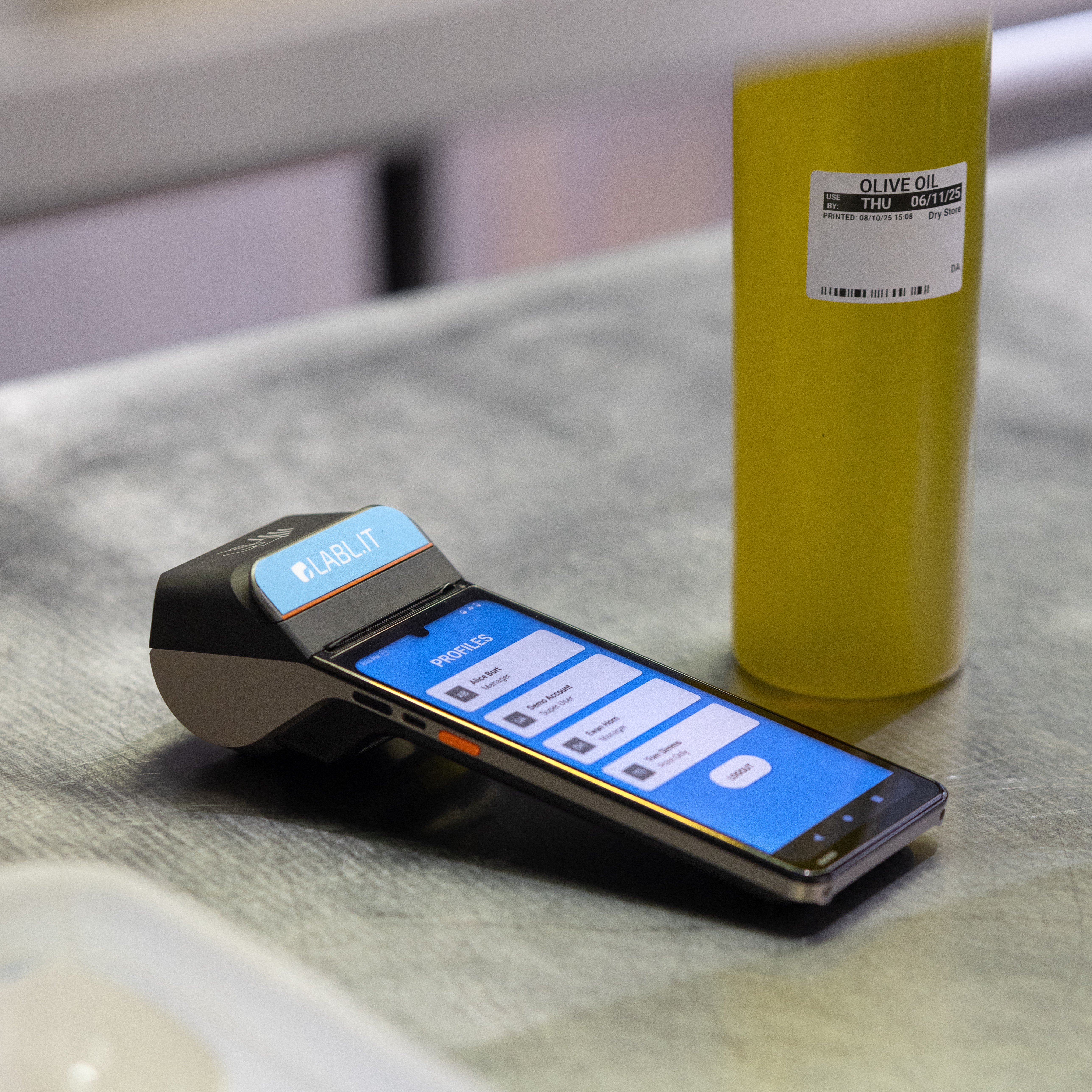 Labl.it device next to bottle of oil