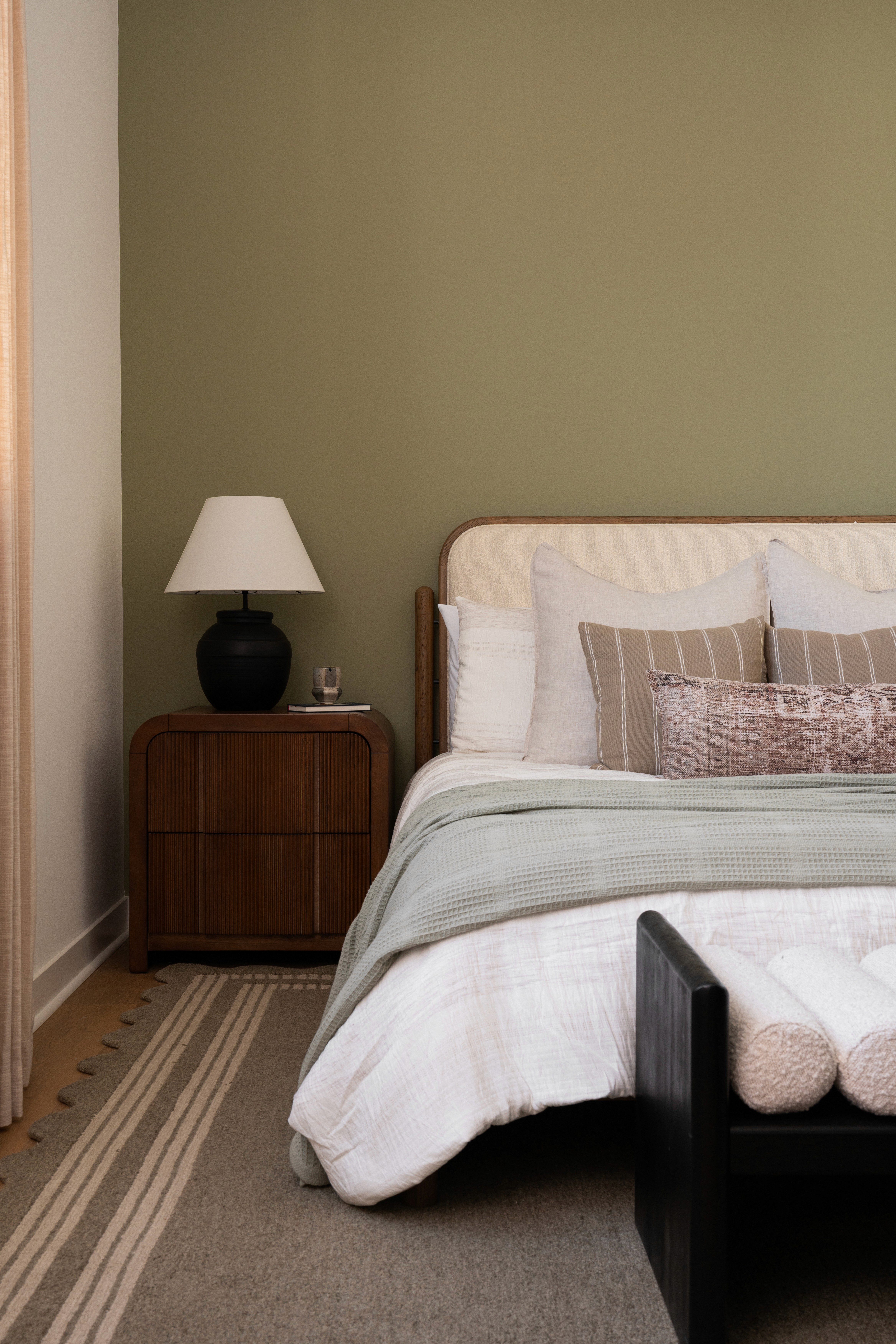 Primary bedroom bed, side table and lamp