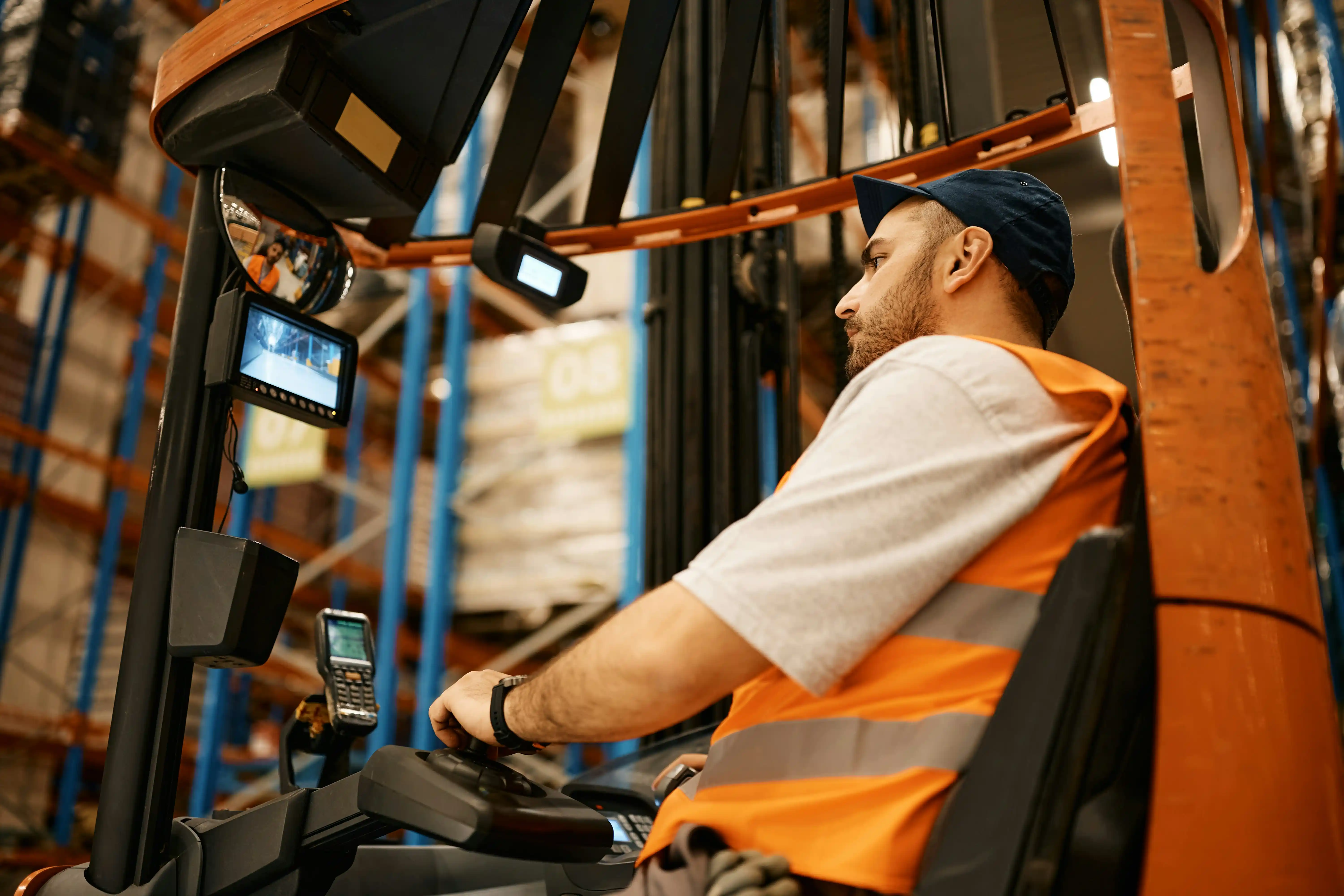 man on a forklift wearing a bright orange high-vis jacket