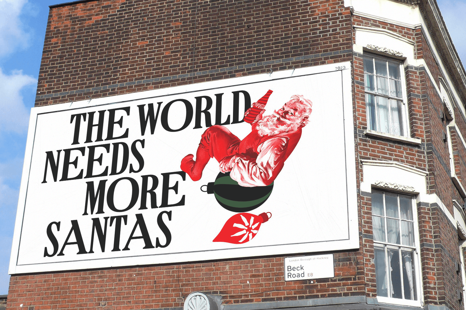 A large billboard on a building reads, "The world needs more Santas," with a festive image of Santa Claus.