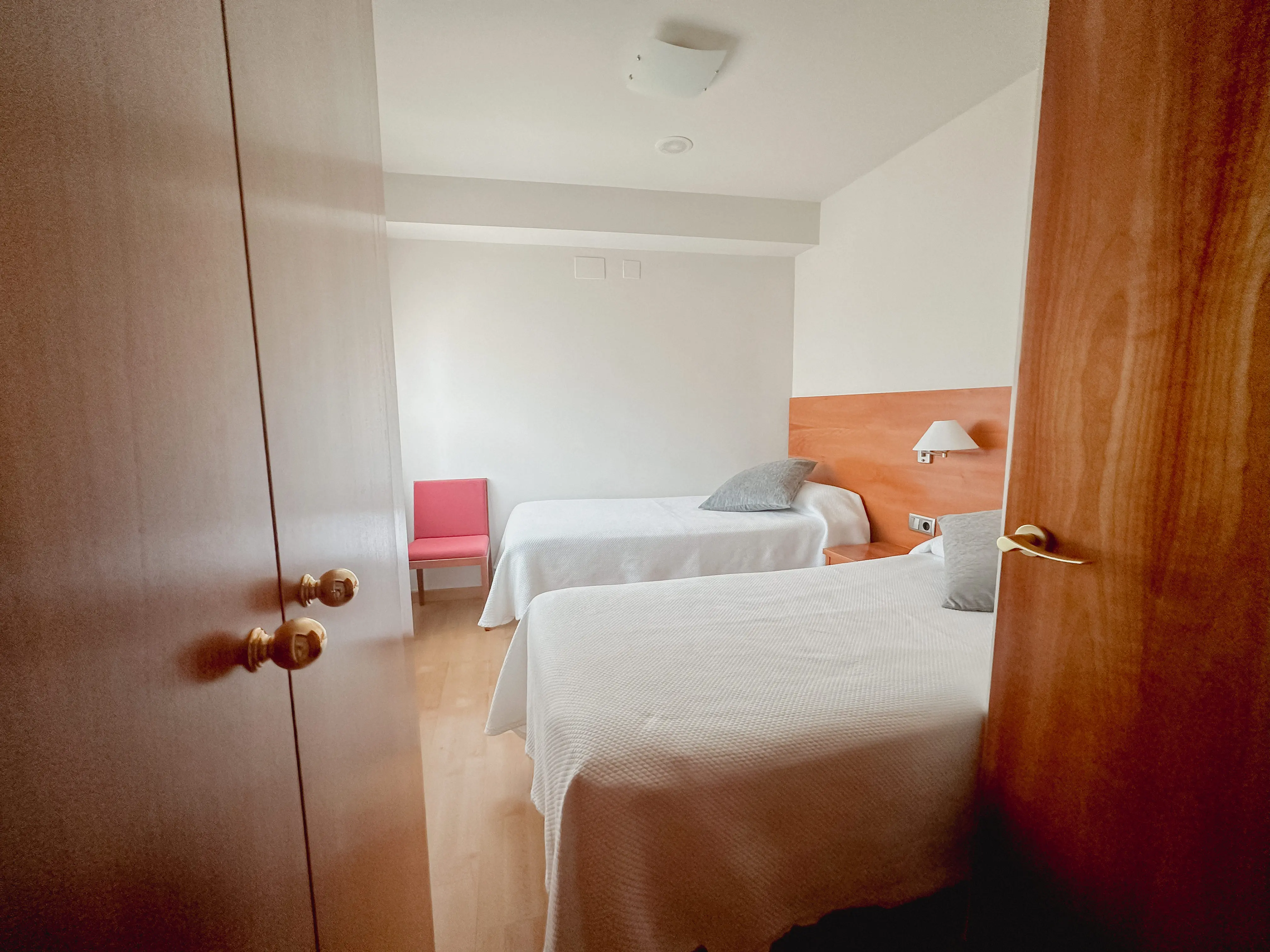 classy bedroom with white rooms, beige bed and blur grey duvet