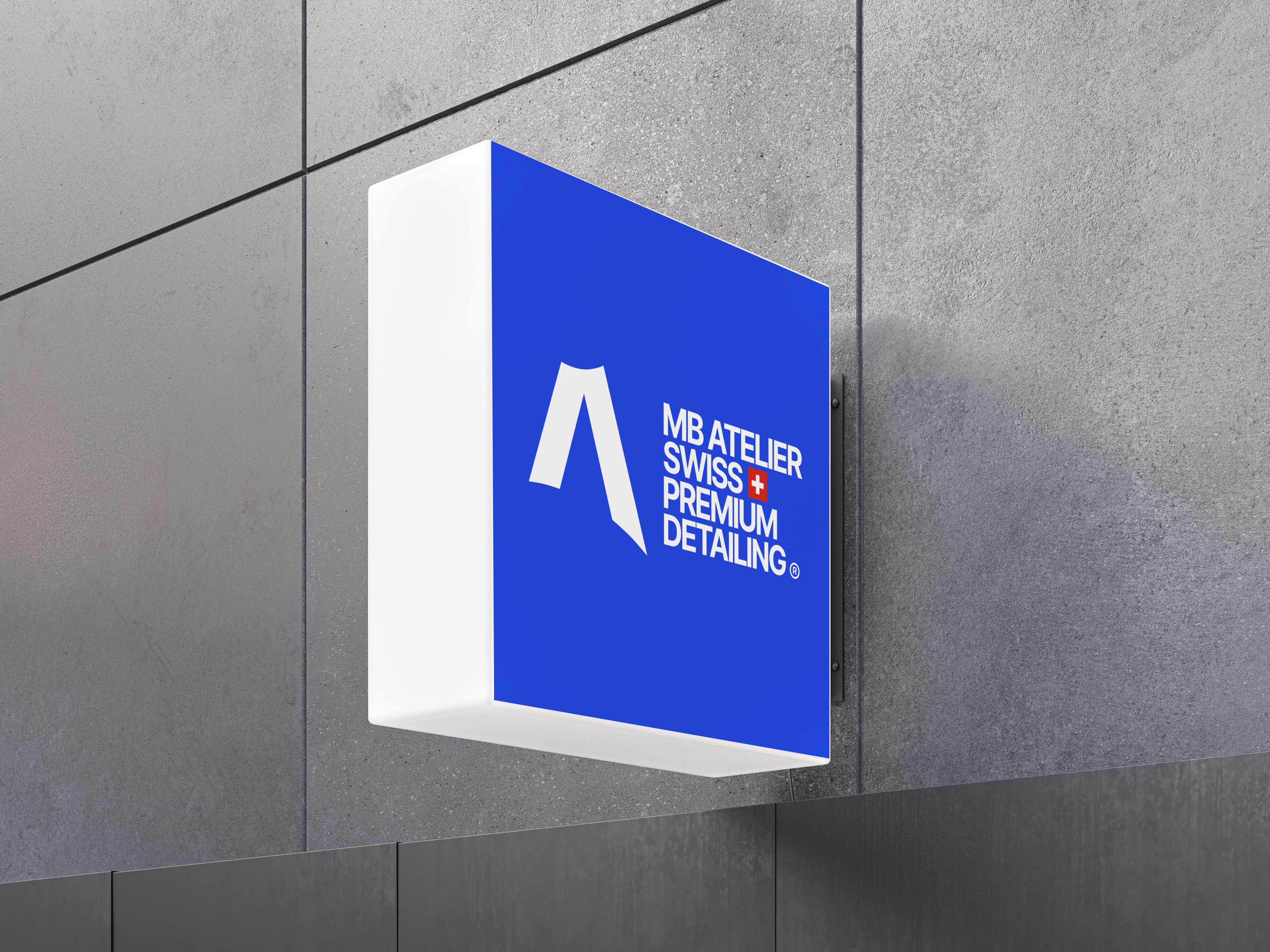 Enseigne murale MB Atelier sur façade grise en gros plan