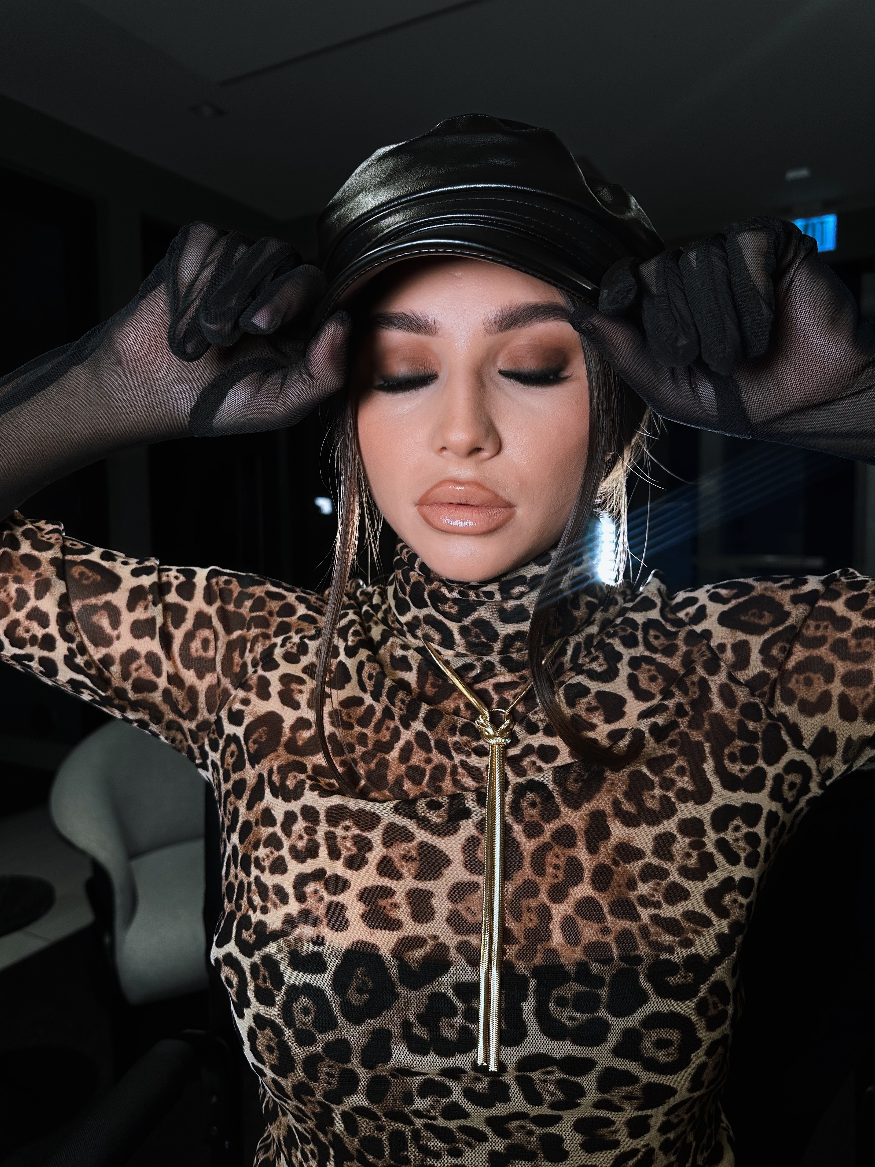 A serene and elegant spa space with wooden reclining chairs and white cushions. Golden sunlight filters through a cascading water feature, creating a peaceful atmosphere. Tropical plants and candles add to the relaxing ambiance.