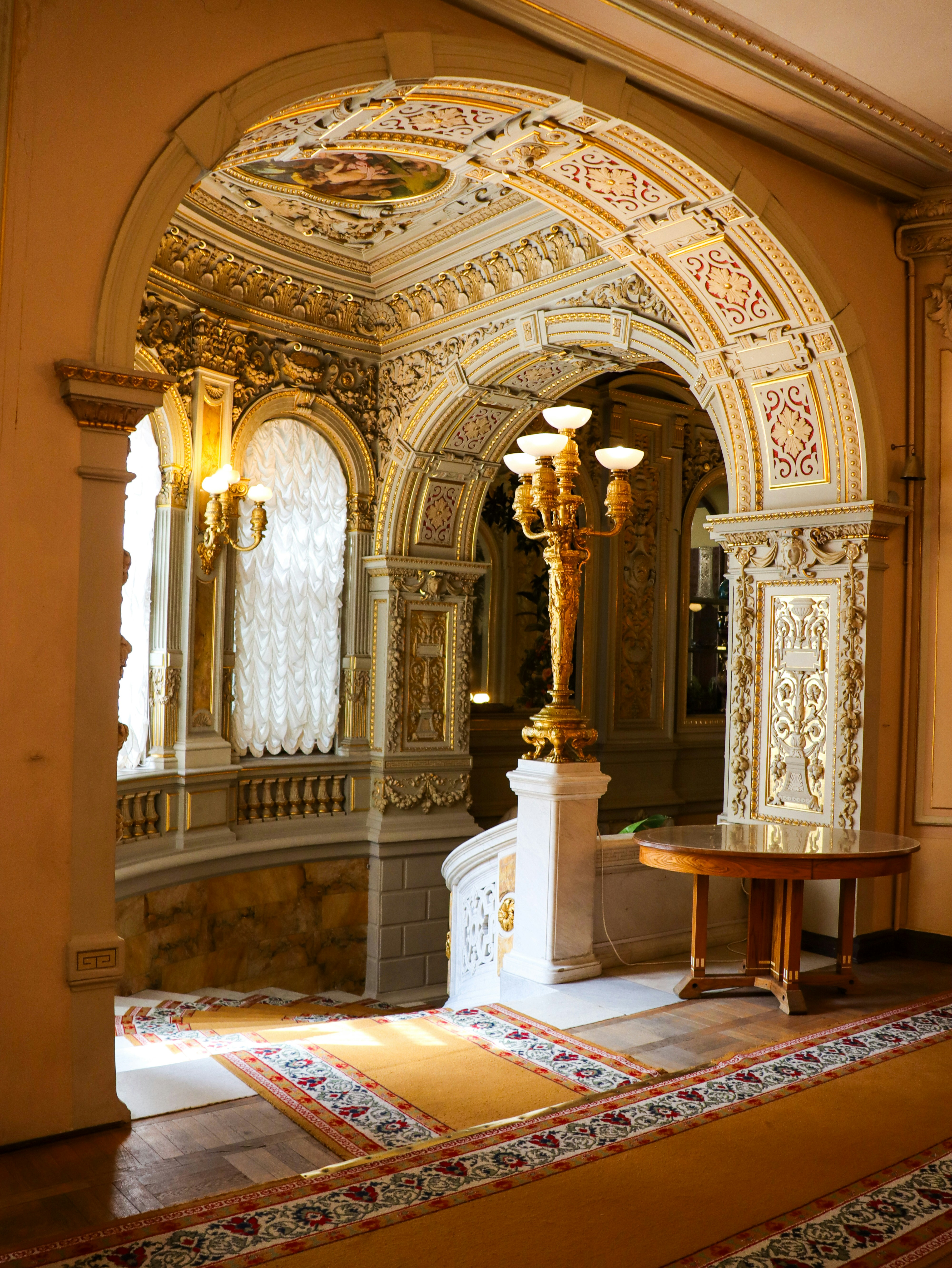 Traditional carpeted stairs descending into a classic, heritage-style hall.