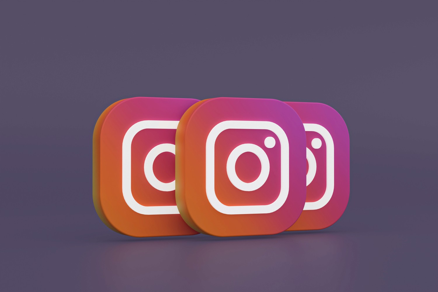 1. Three Instagram icons displayed on a vibrant purple background, showcasing social media connectivity and engagement.