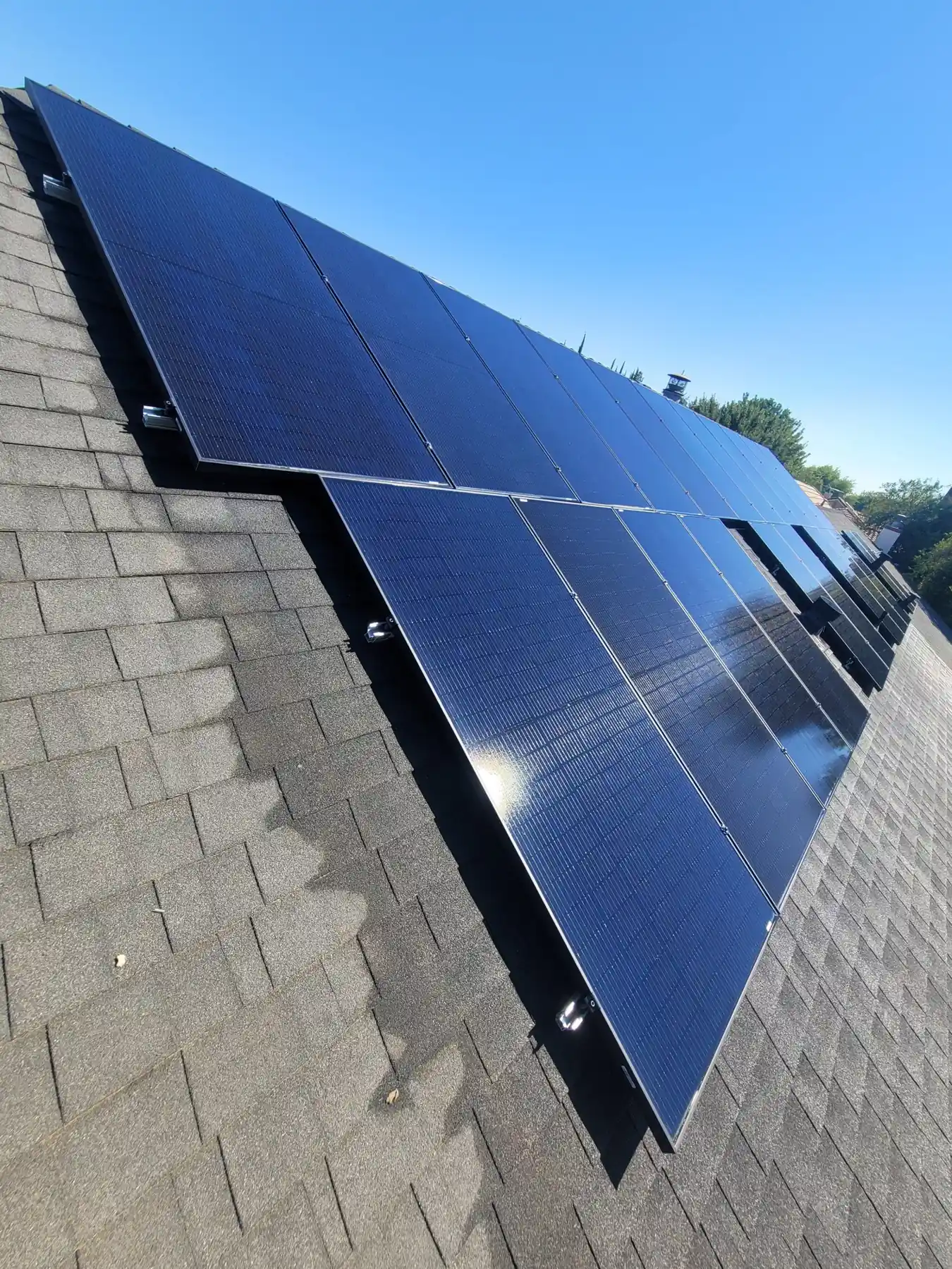Rooftop solar panels against a blue sky | Premier Solar Service, serving Fresno, CA