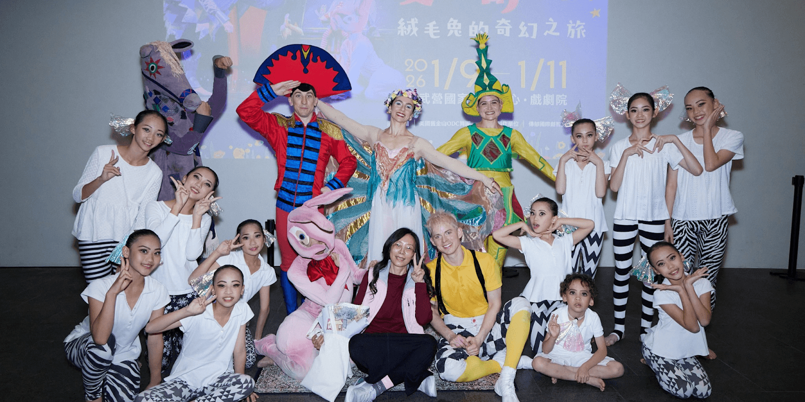 A group of performers, including dancers in costumes, posing with Dr. Sophia Huang, showcasing the inclusion in I.P.A.C.'s event.
