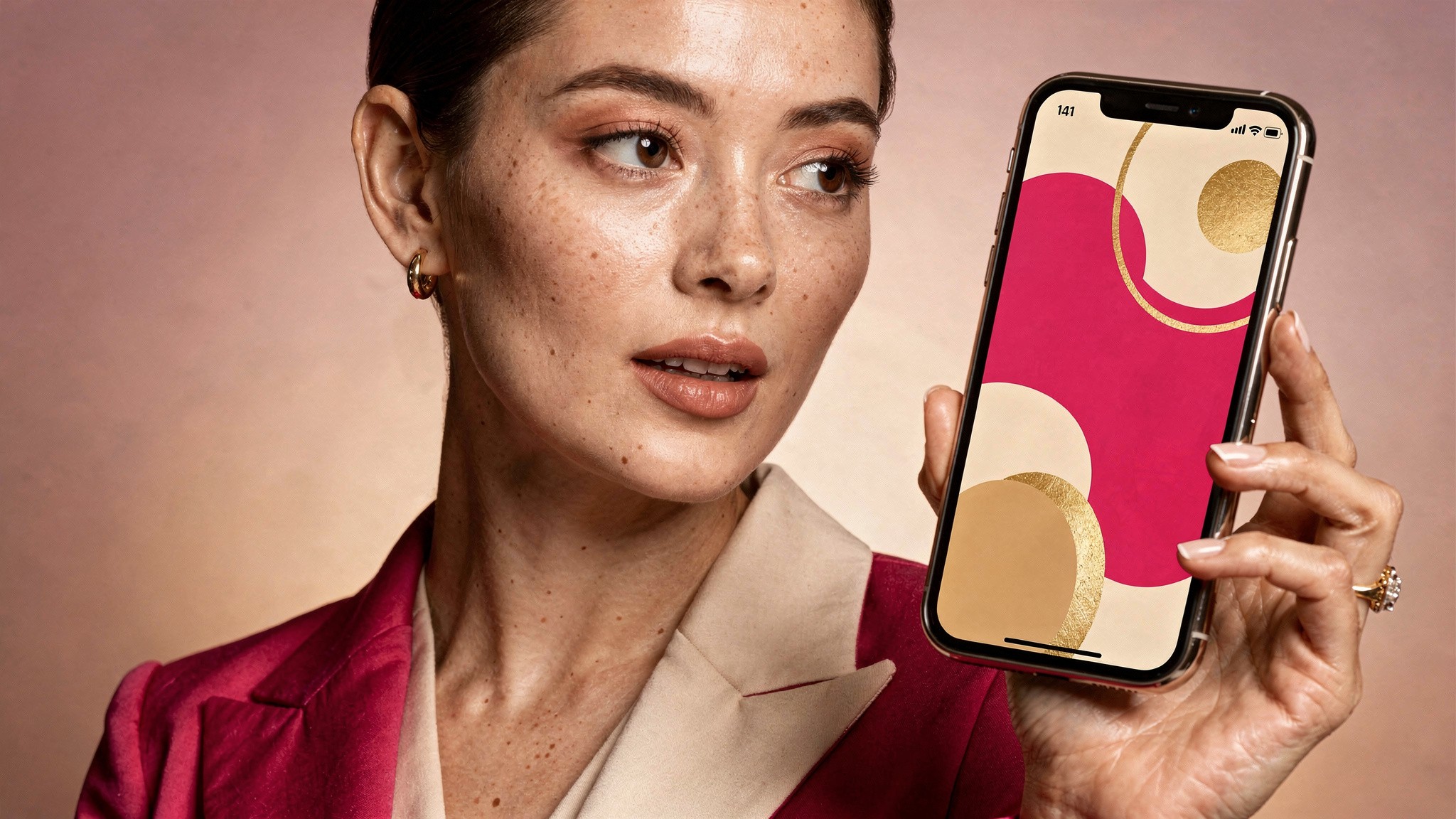Adult creator holding a phone showing a striking first carousel slide in a pink editorial studio