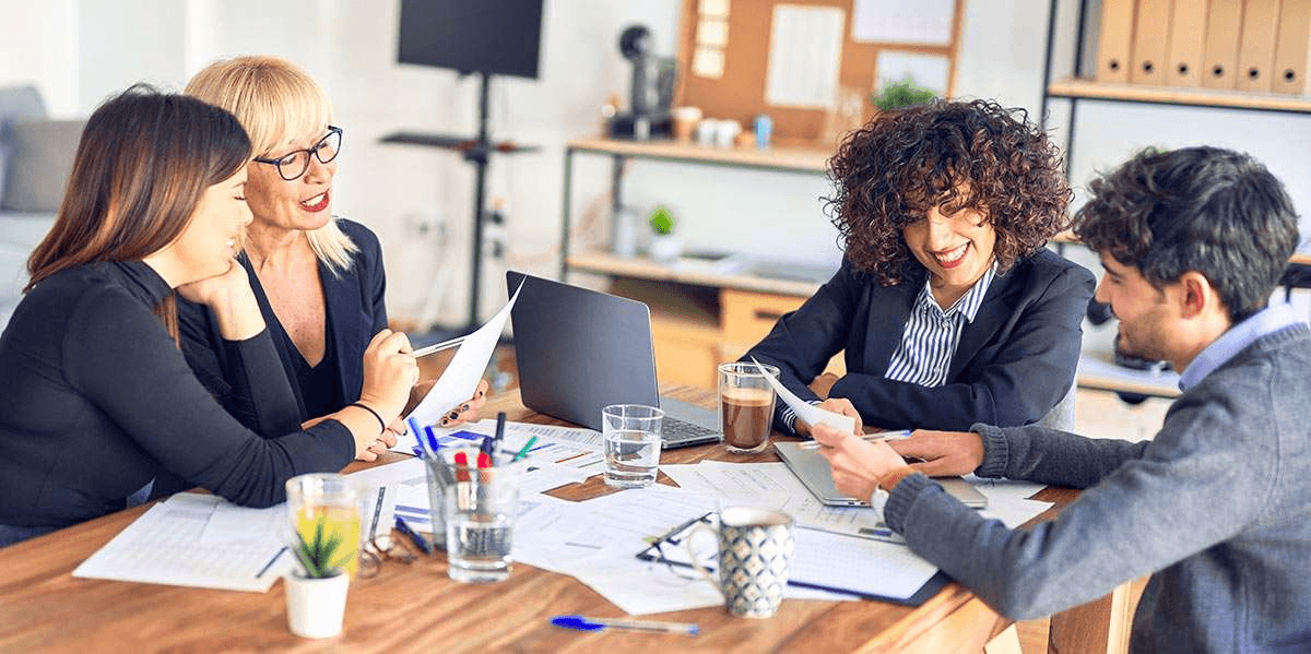 Team members sharing documents - Knowledge Management Lifecycle