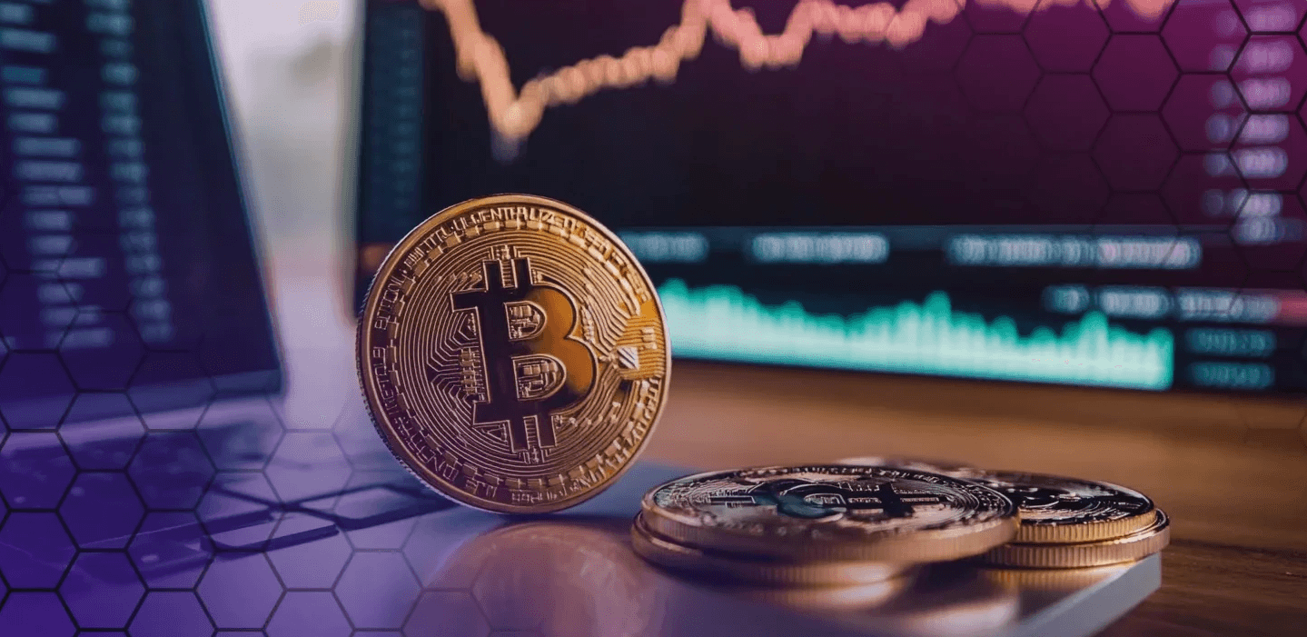 Bitcoin coins resting on a laptop - Best Crypto to Swing Trade