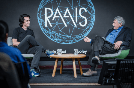 Image of 2 speakers sitting on stage conversing at RAAIS