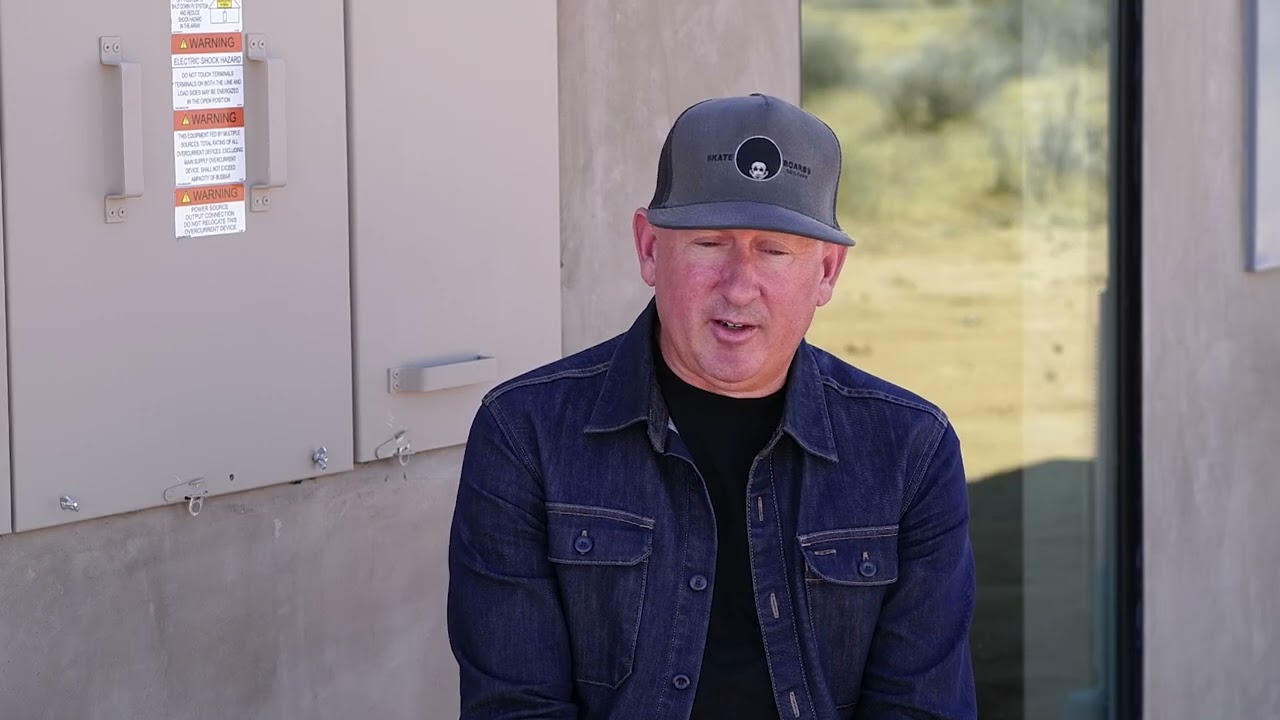 Video still: Chris Fortuna at home in High Desert talking about their solar installation