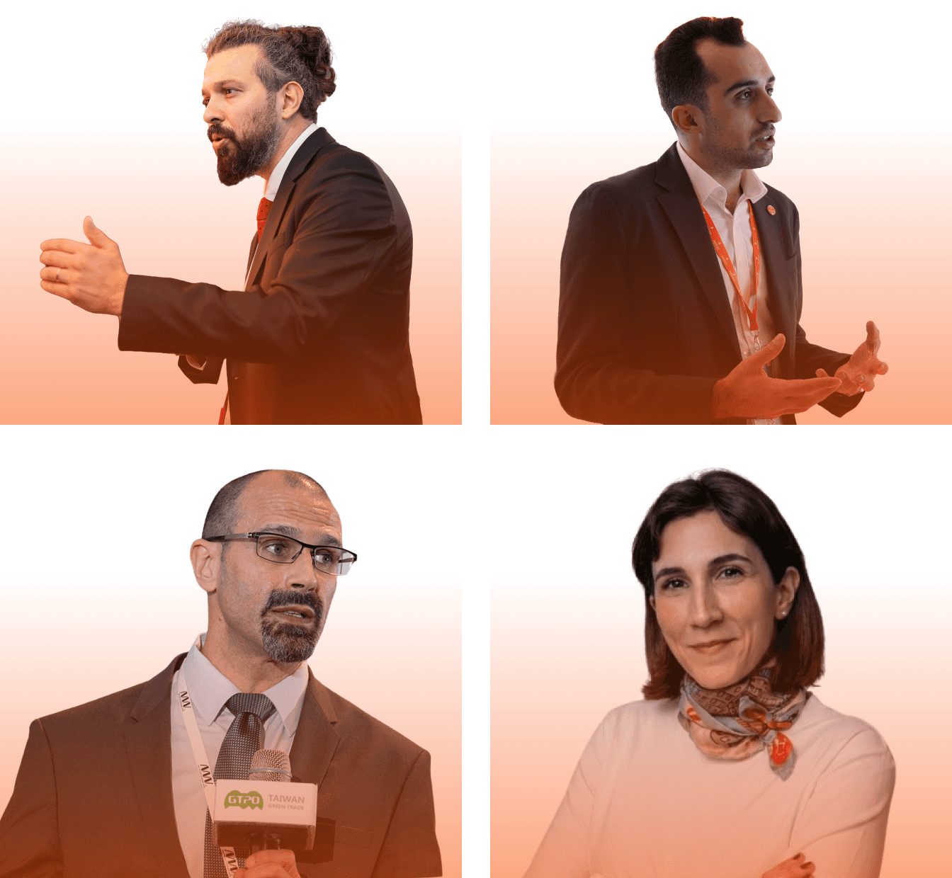 A diverse group of people poses together in front of a bright, red backdrop at an event or conference.