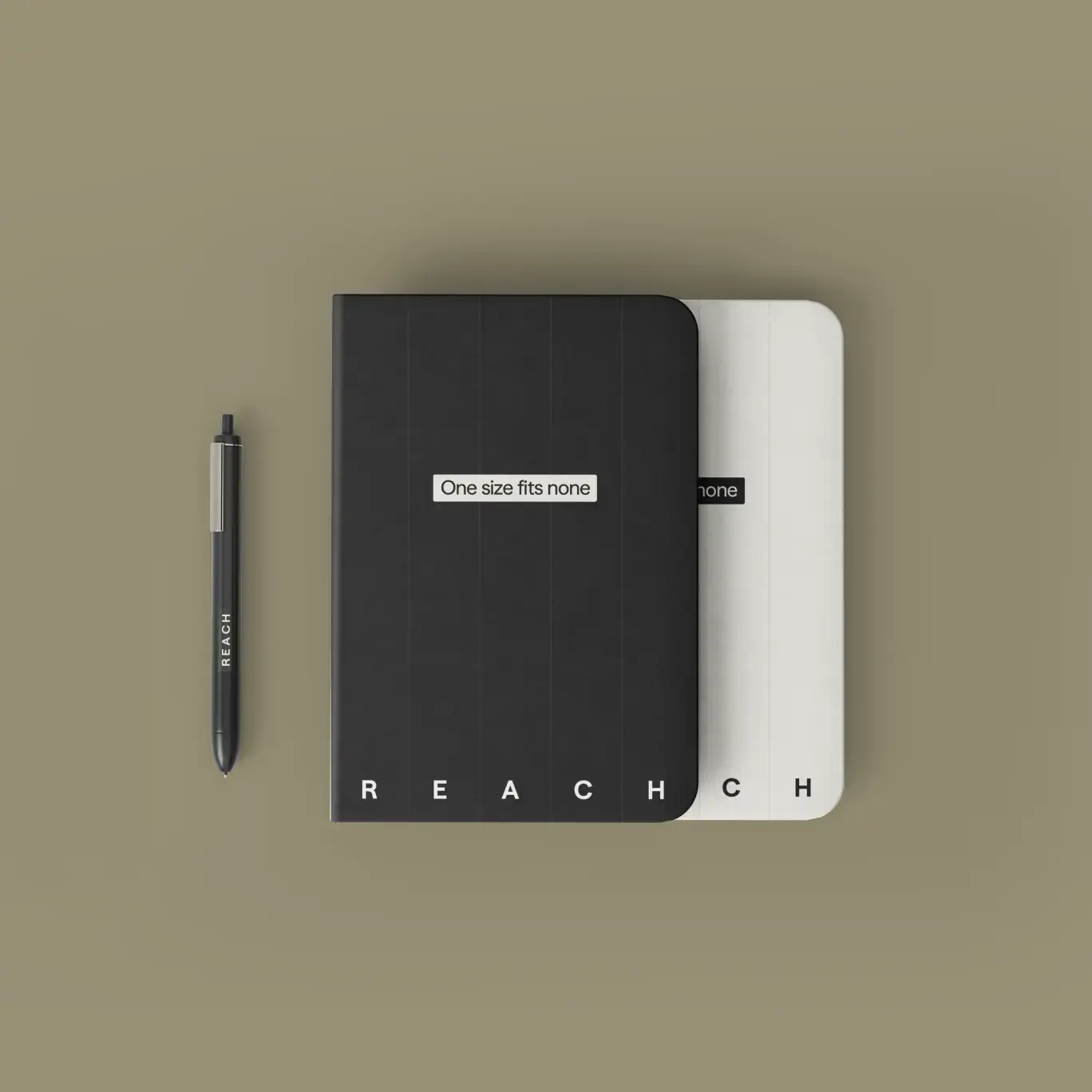 Black and white Reach notebooks with the tagline “One size fits none,” beside a branded pen on an olive background.