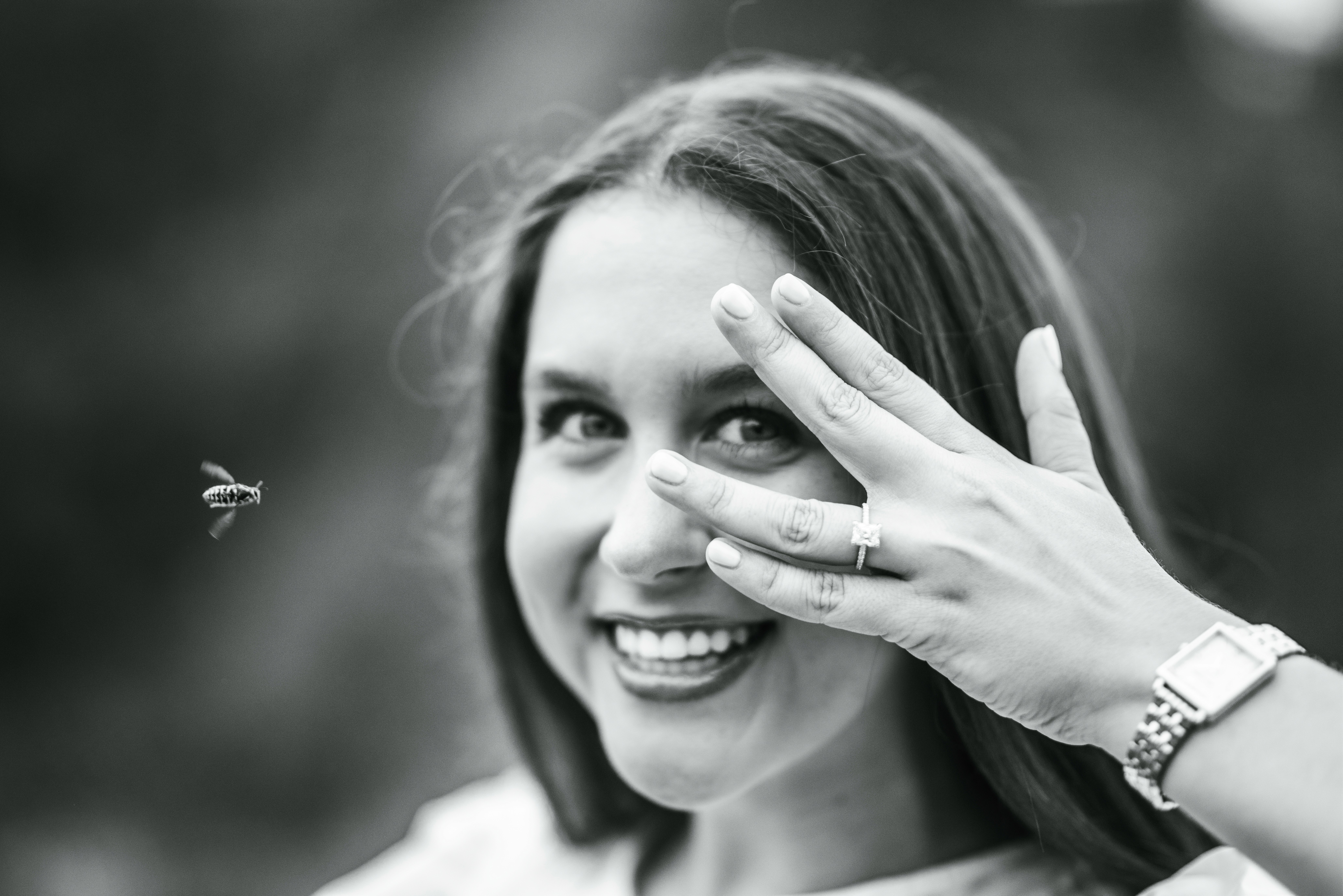 couple embracing one another in front of a lake