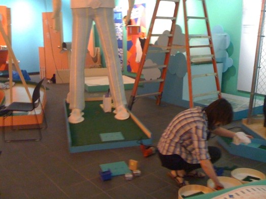 a person working on installation of golf course sculptures and courses