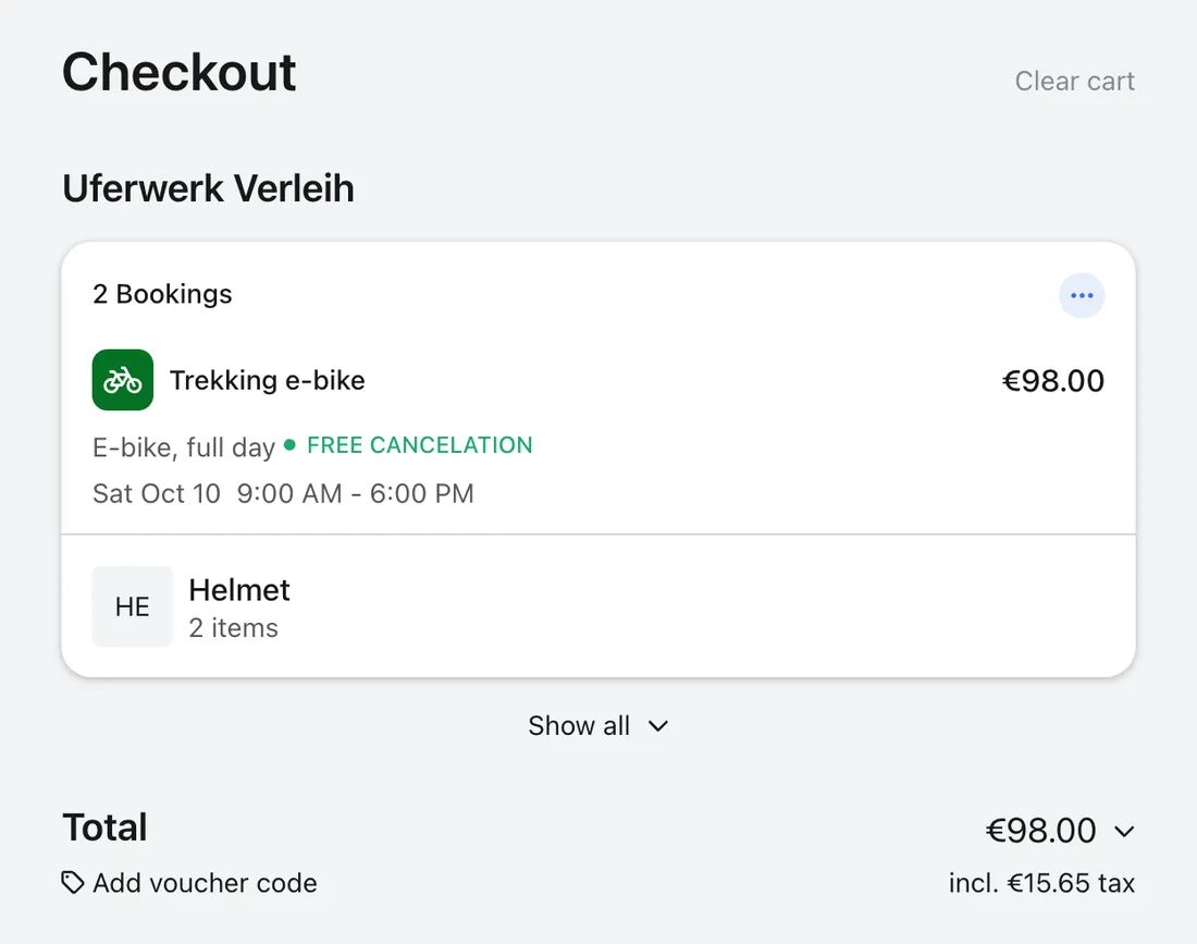 Cart with two e-bike bookings and two helmets, total €98