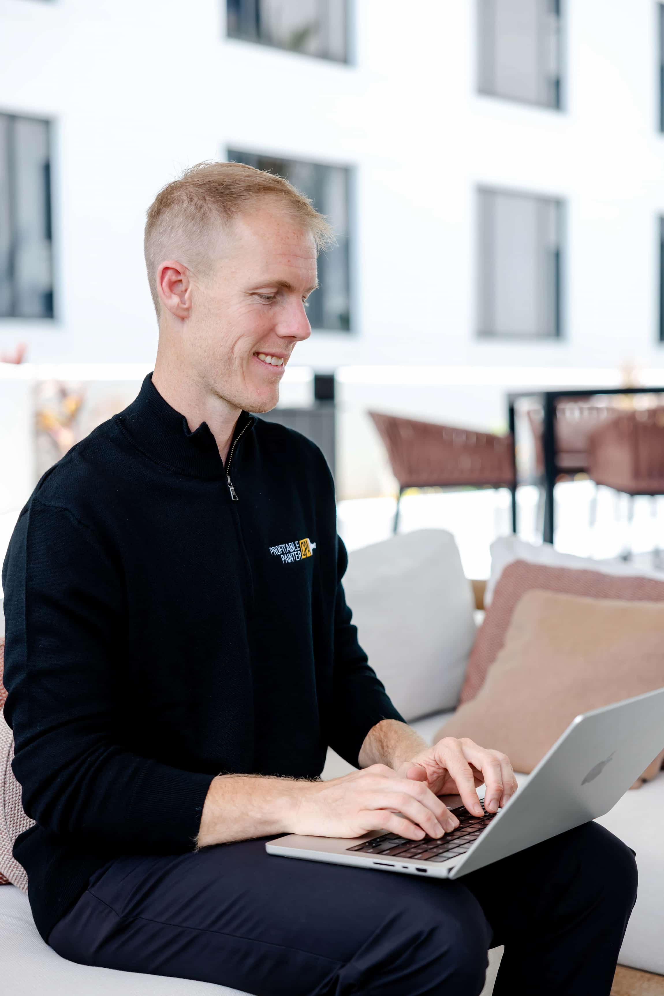 Image of Daniel Honan working at computer smiling.
