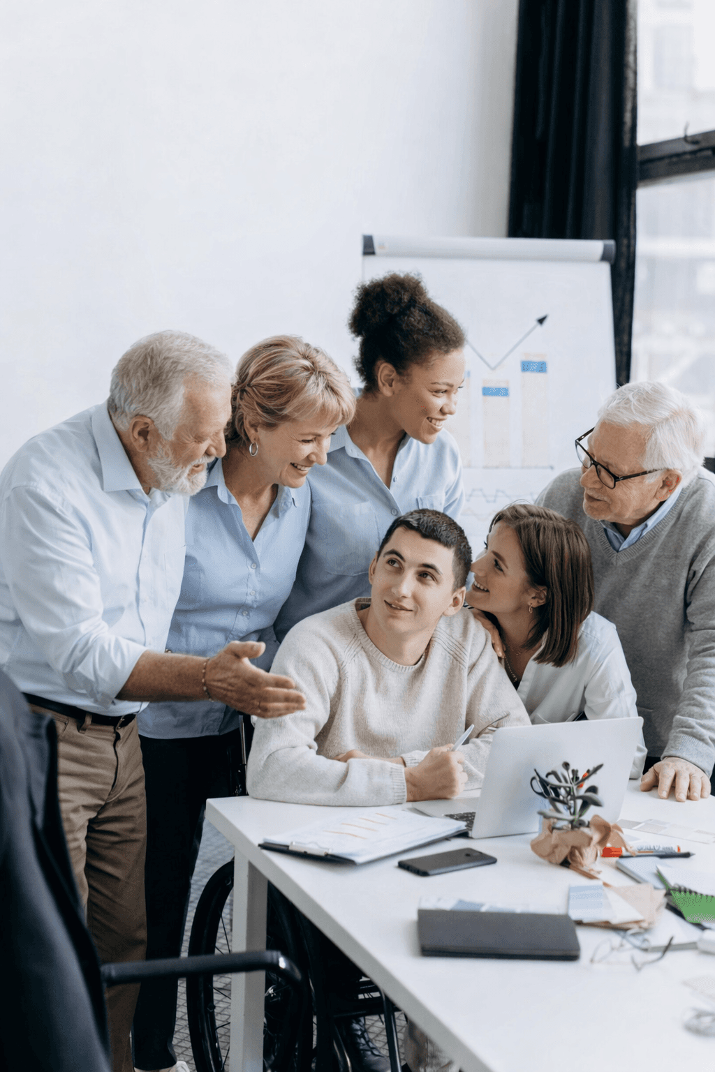 woman sitting around table holding tablet