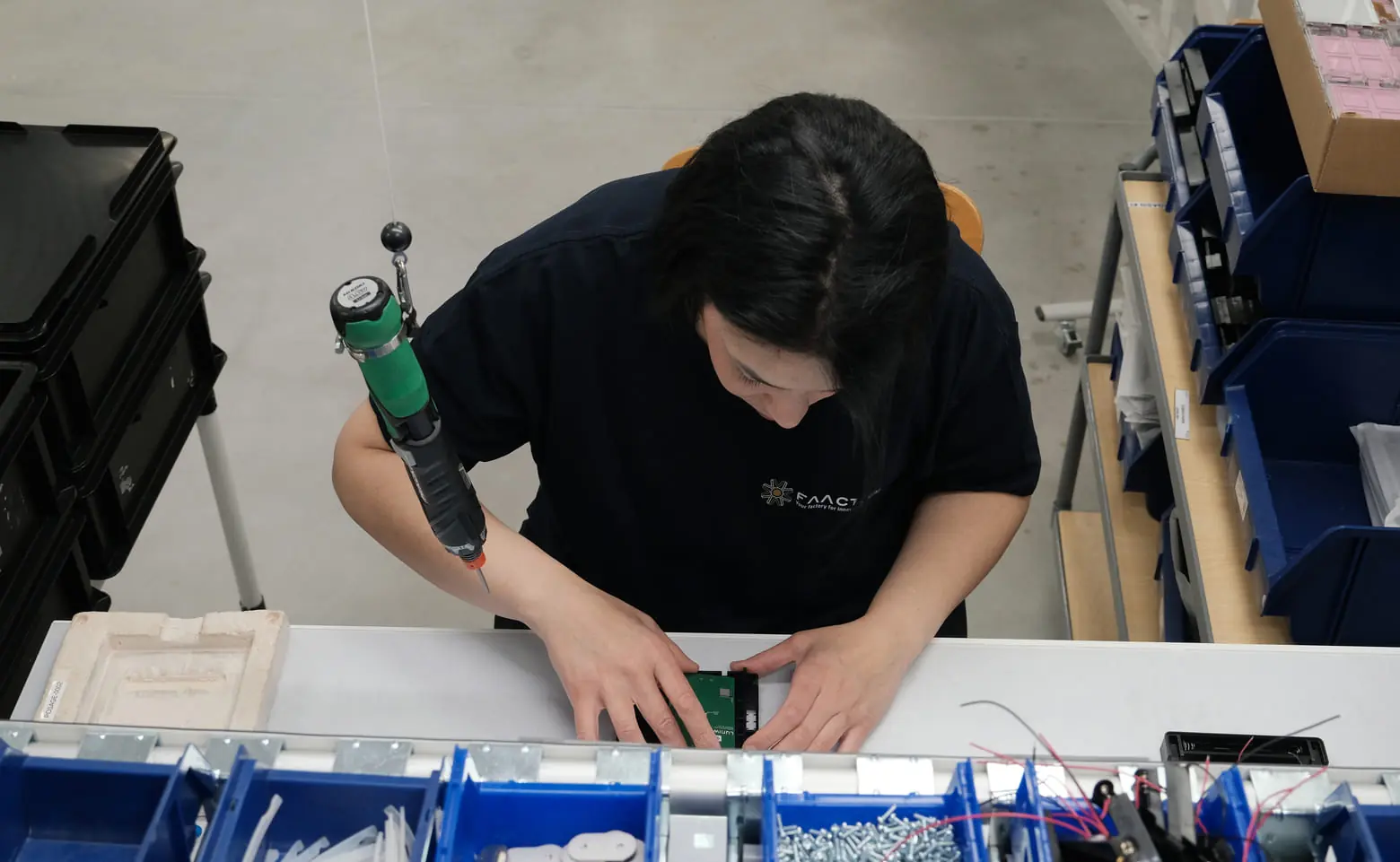 Operator assembling a part, top view