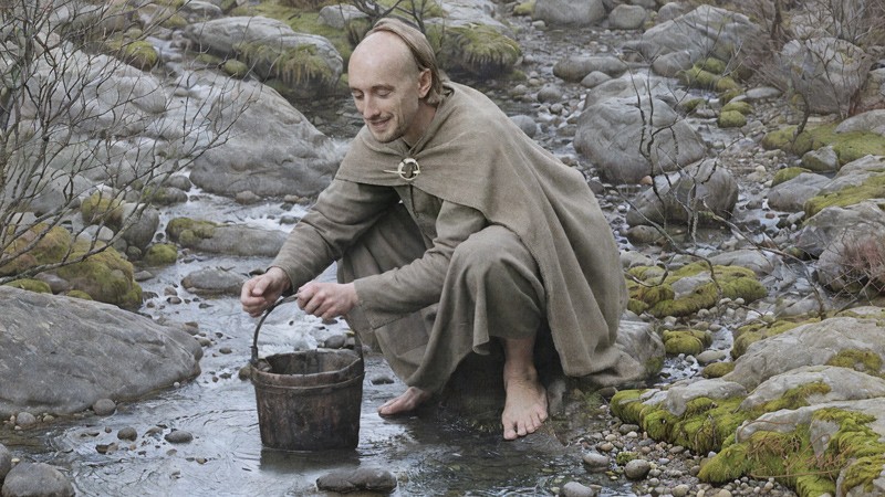 Sacred artwork by Faith and Verse. © Faith and Verse, 2026. All rights reserved. Young Saint Deicolus collecting water from a rocky stream, Ireland, early 6th century.