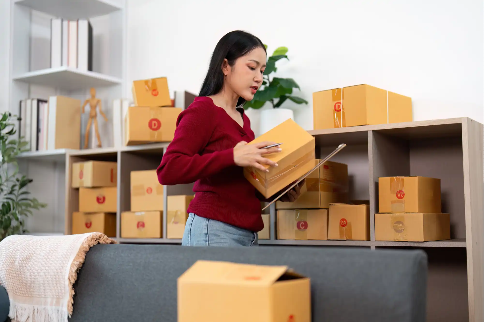 Online seller managing inventory boxes illustrating TikTok Shop's marketplace operations and extended return policy impact