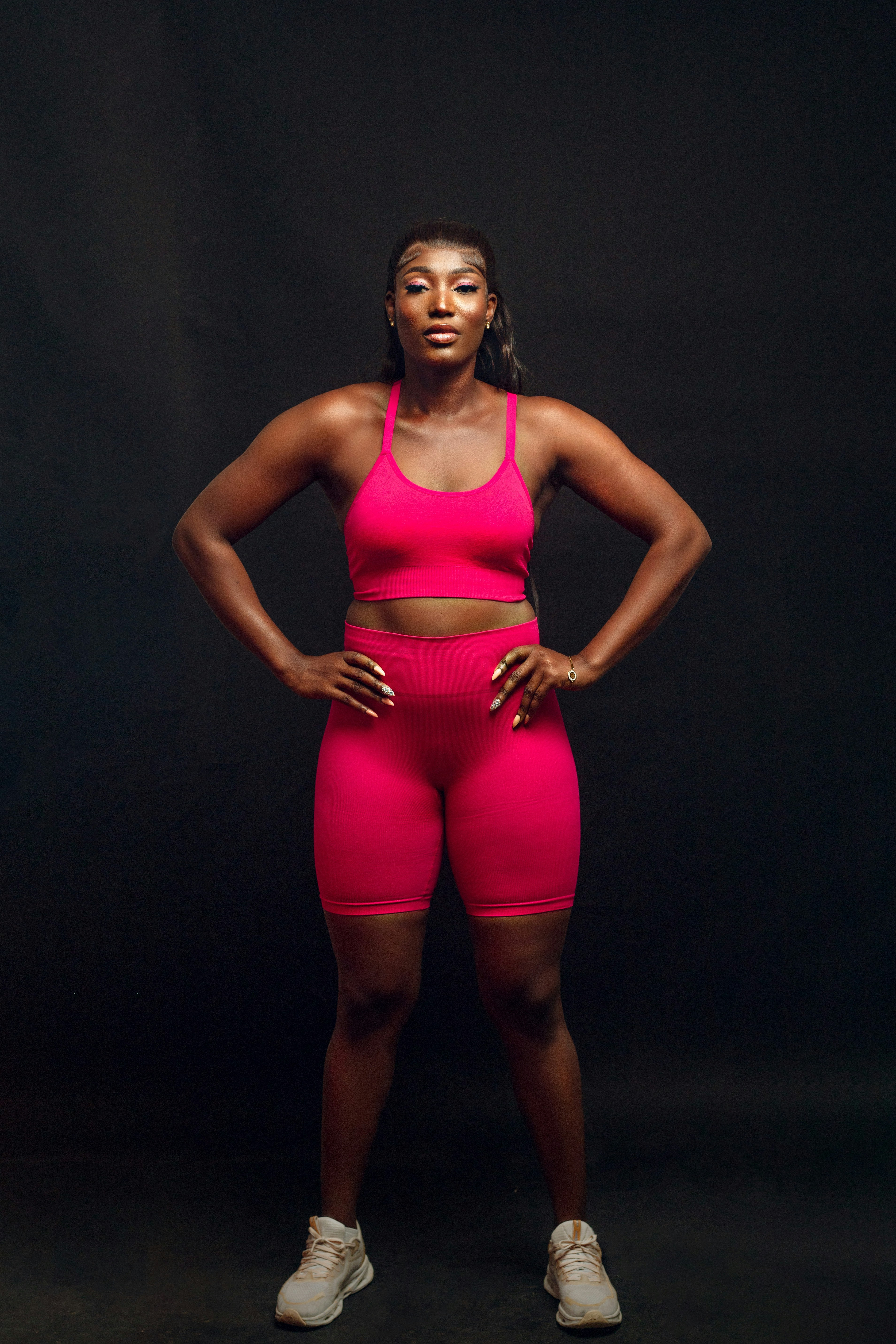 A woman in a pink sports bra and shorts