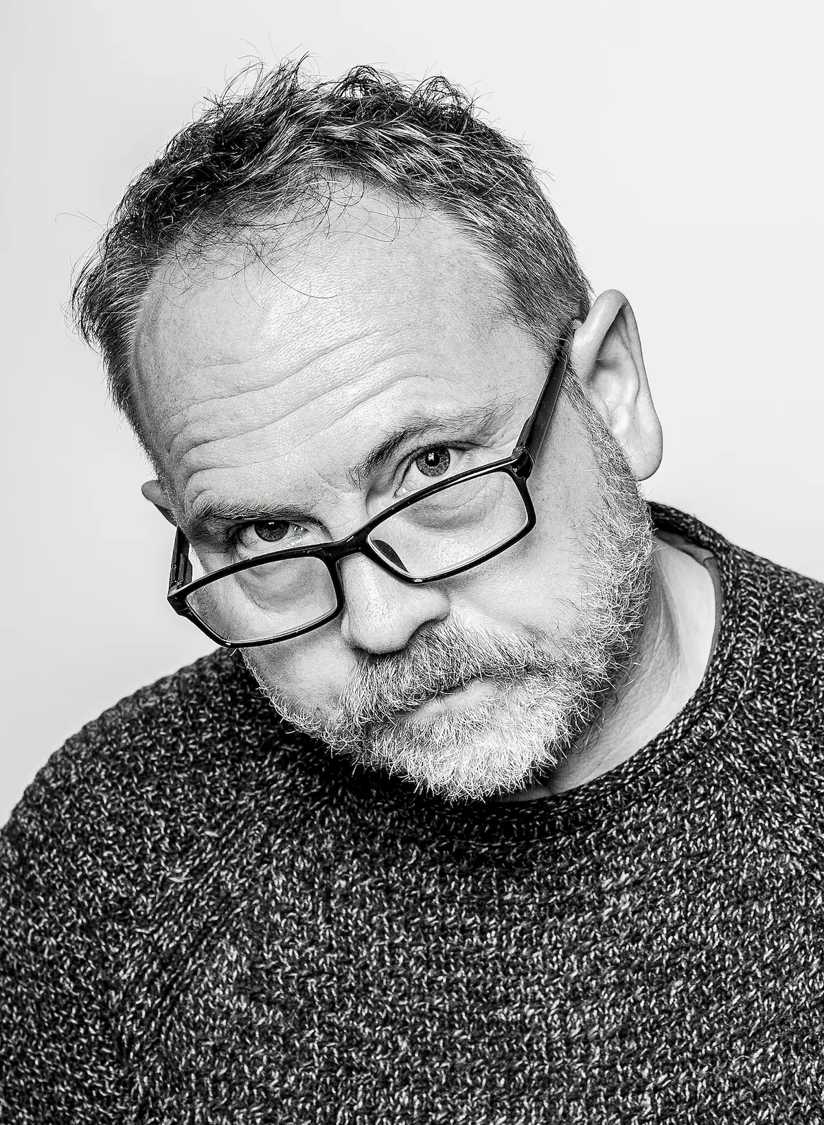 Black-and-white portrait of a Meridian Studio team member in front of a window