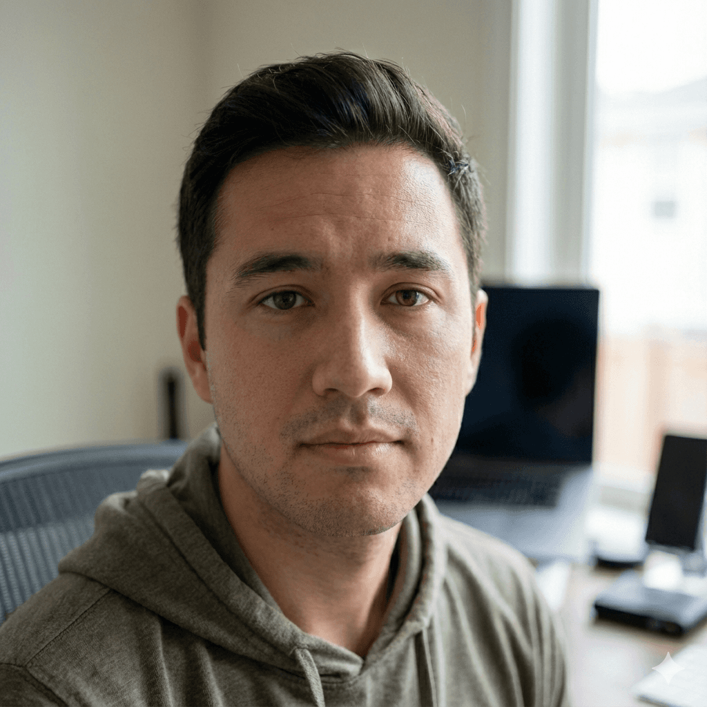 a man with a goatee smiles at the camera