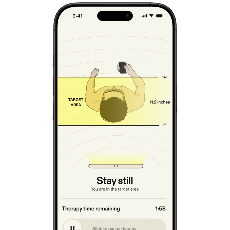Mobile app screen instructing the user to stay still, showing a highlighted target area with distance measurements to ensure proper positioning.