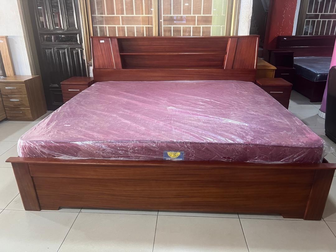 a gray couch with a wooden base on a gray background