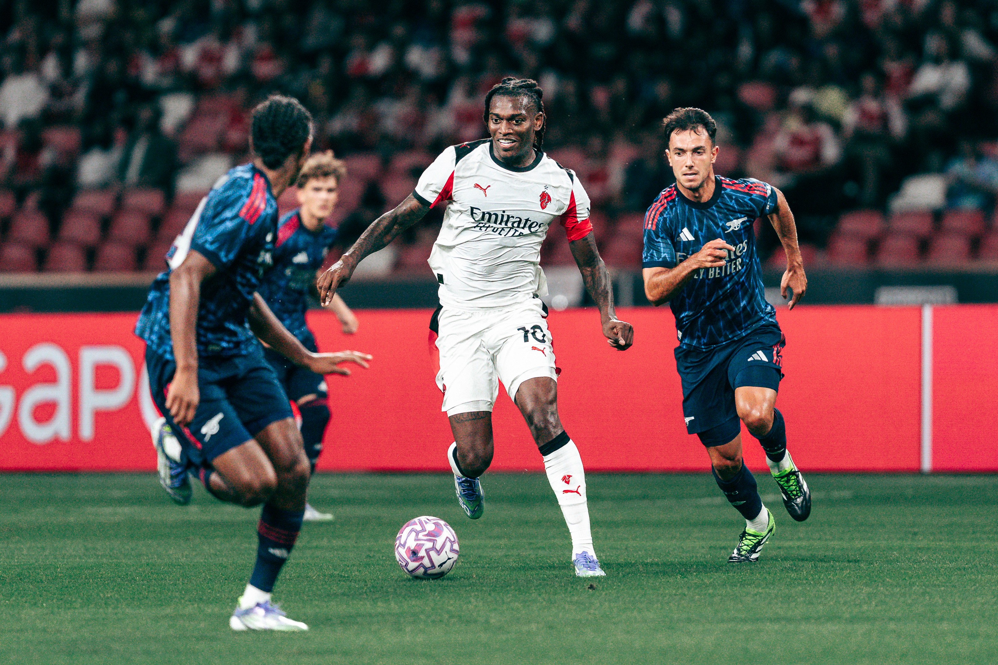 Rafael Leão dribbles during a match between Arsenal and A.C. Milan at the National Stadium in Singapore for the Singapore Festival of Football 2025