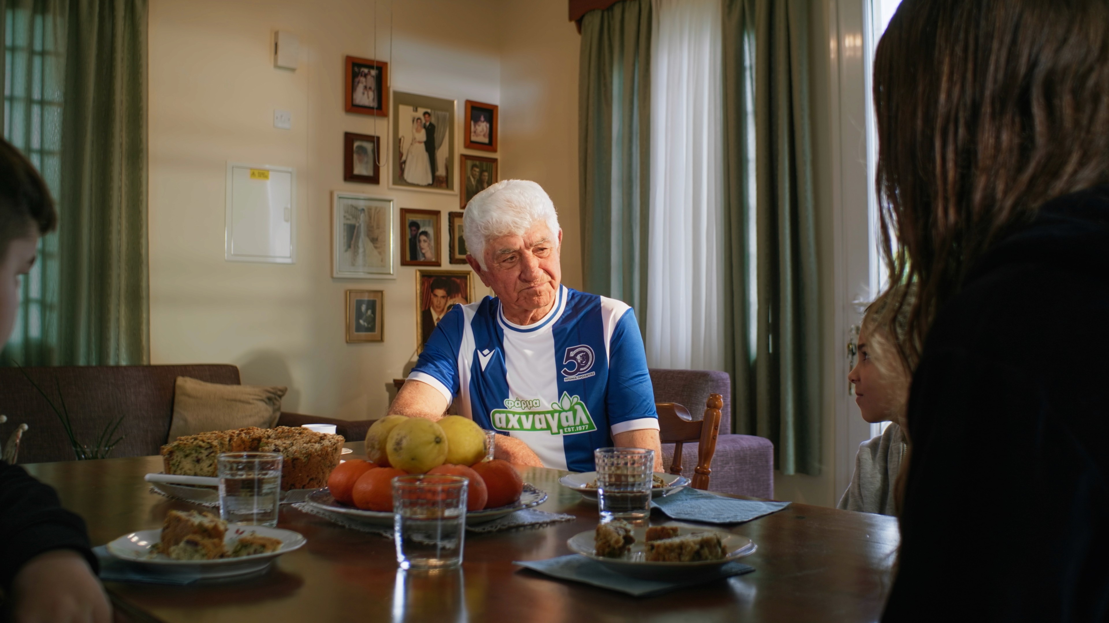 Old man at his house with his grandchildren