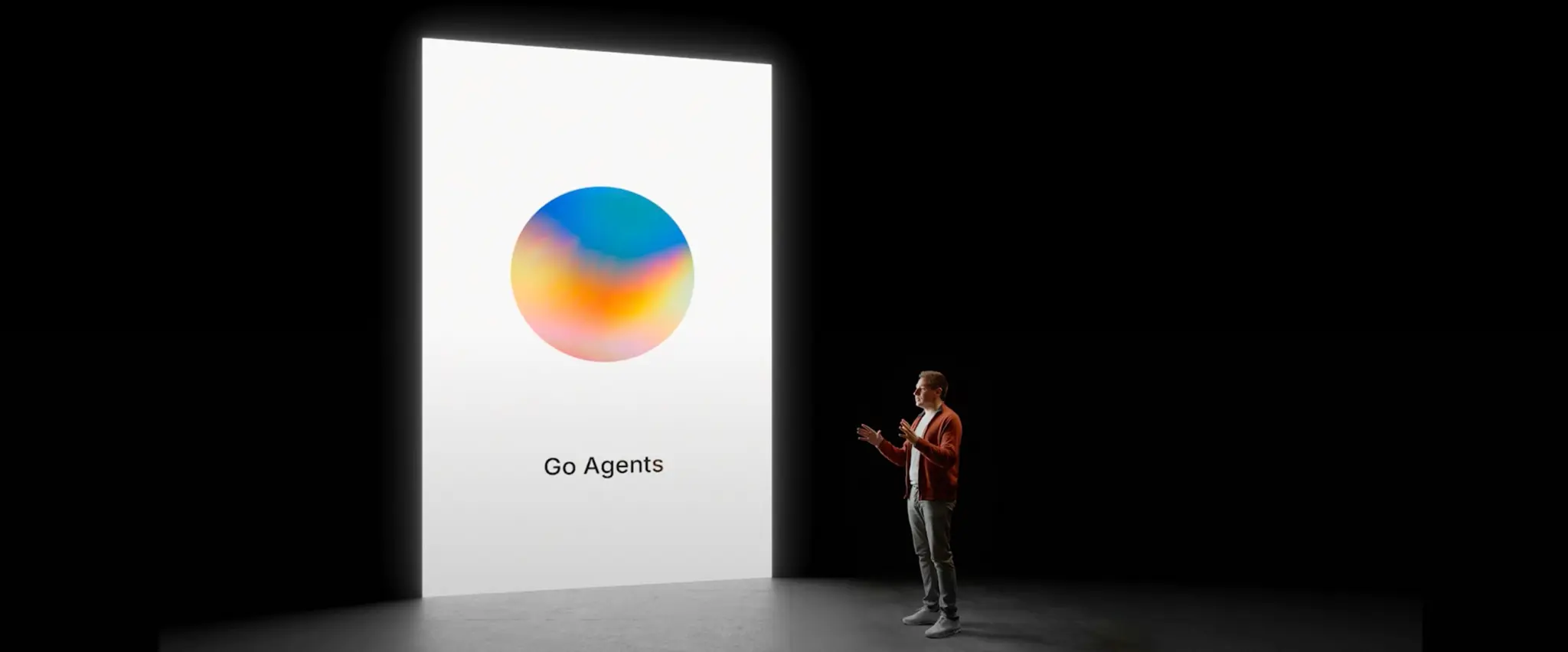 Man presenting "Go Agents" with animated orb