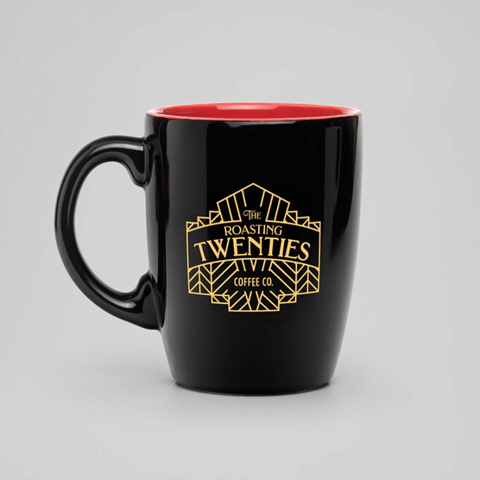 The Roasting Twenties Logo Mocked up on a coffee cup