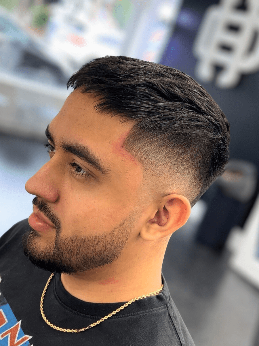 person holding white and gold hair comb