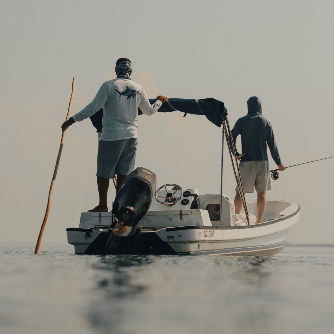 Placencia guide Marlon Leslie on the back of his boat guiding a saltwater angler