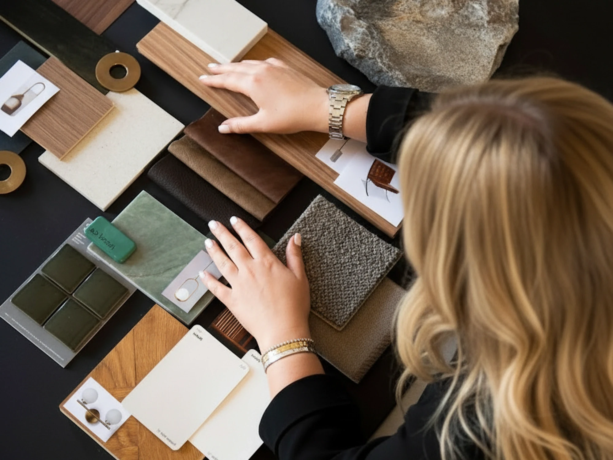Designer reviewing architectural materials and color swatches at a workspace.